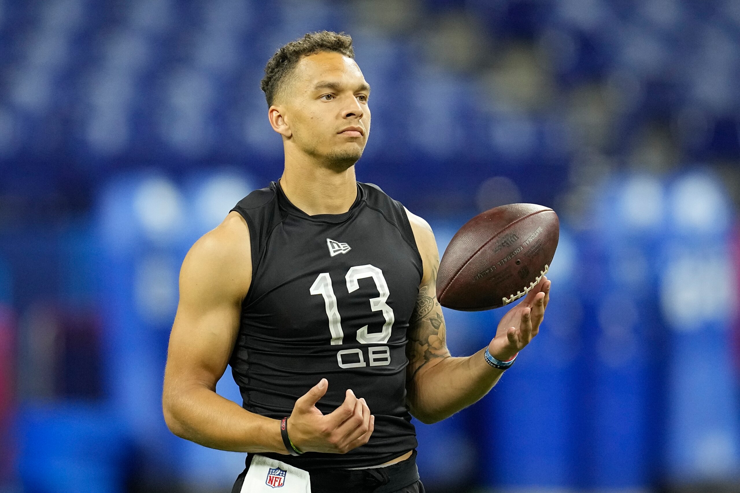 Cincinnati quarterback Desmond Ridder runs a drill during the NFL football scouting combine, Thursday, March 3, 2022, in Indianapolis. (AP Photo/Darron Cummings)