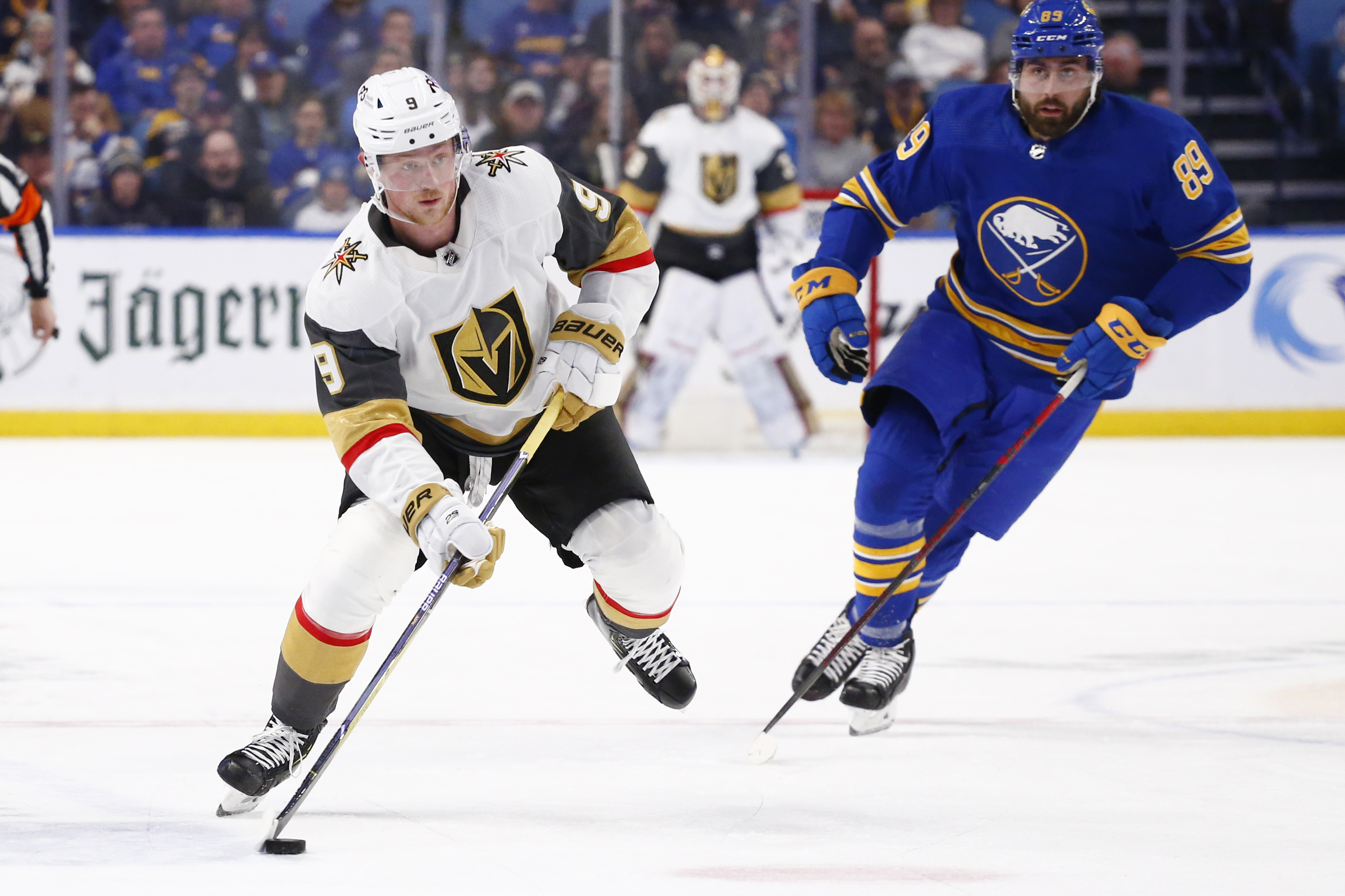 Vegas Golden Knights center Jack Eichel (9) carries the puck past Buffalo Sabres right wing Alex Tuch (89) during the first period of an NHL hockey game, Thursday, March 10, 2022, in Buffalo, N.Y. (AP Photo/Jeffrey T. Barnes)