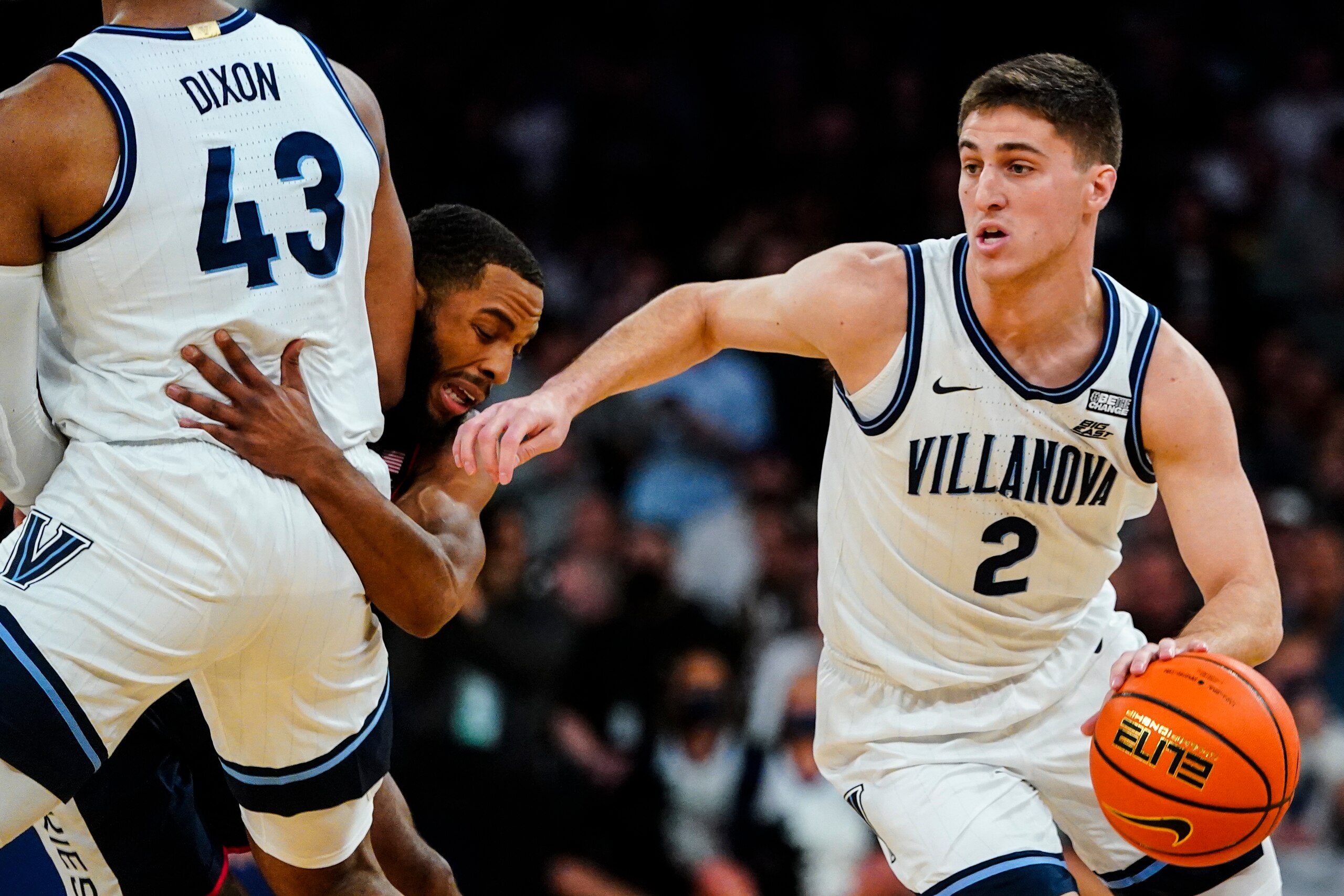 Villanova's Collin Gillespie (2) uses a screen by Eric Dixon (43) as Connecticut's R.J. Cole defends during the first half of an NCAA college basketball game in the semifinals of the Big East men's tournament Friday, March 11, 2022, in New York. (AP Photo/Frank Franklin II)