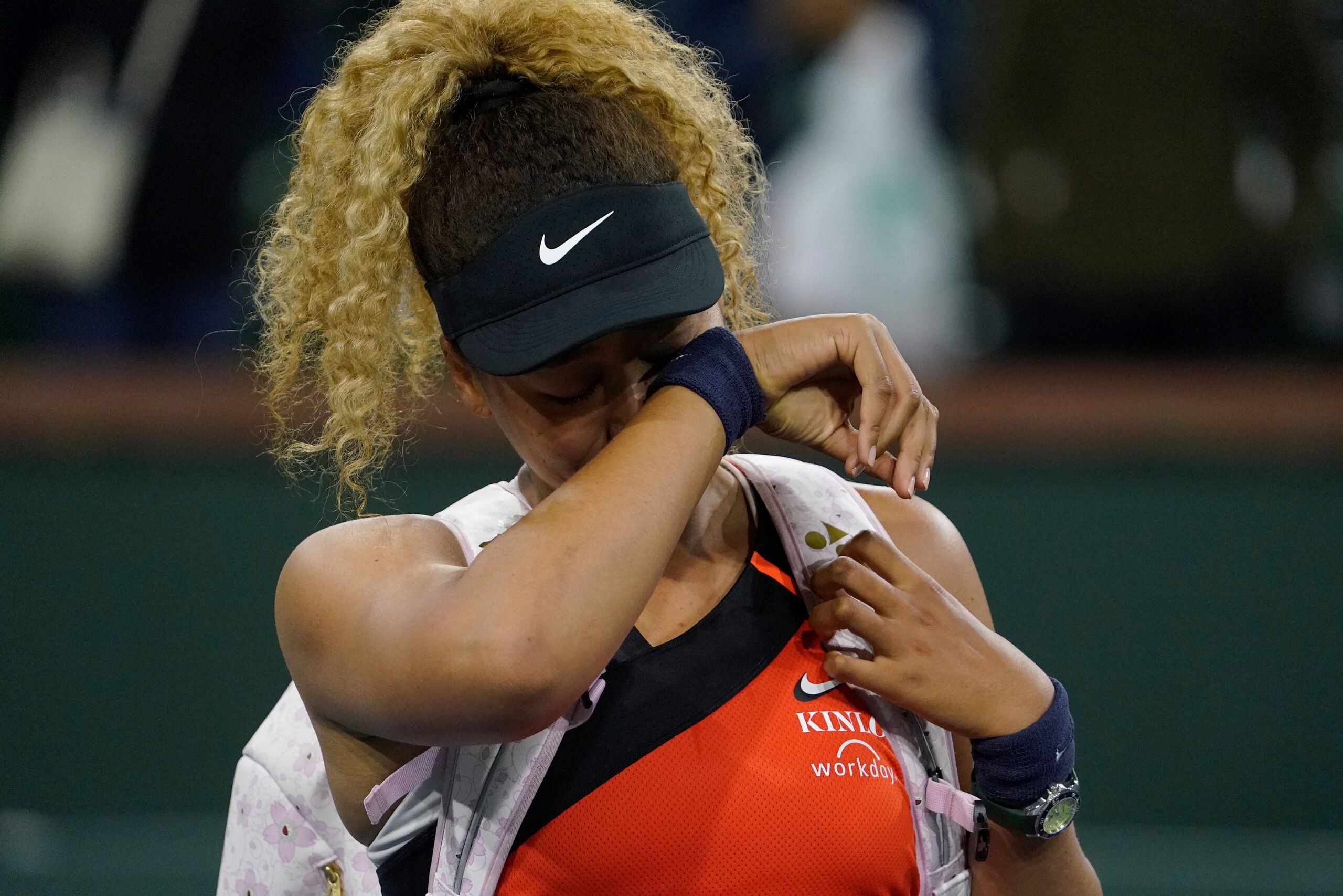 Naomi Osaka, of Japan, wipes away tears as she leaves the court after losing her match to Veronika Kudermetova, of Russia, at the BNP Paribas Open tennis tournament Saturday, March 12, 2022, in Indian Wells, Calif. (AP Photo/Mark J. Terrill)