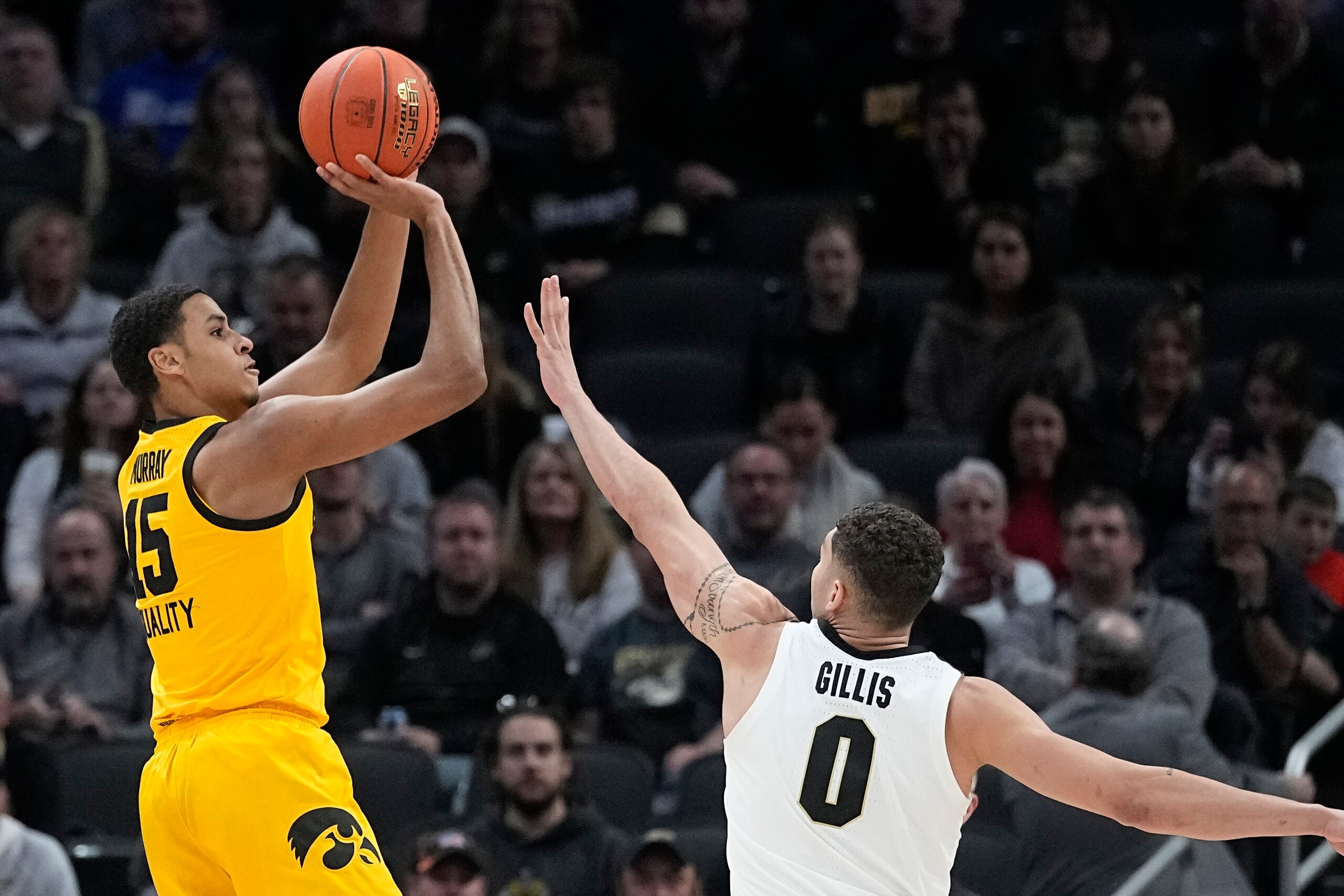 Iowa forward Keegan Murray (15) shoots over Purdue forward Mason Gillis (0) during the first half of an NCAA college basketball game at the Big Ten Conference tournament, Sunday, March 13, 2022, in Indianapolis. (AP Photo/Darron Cummings)