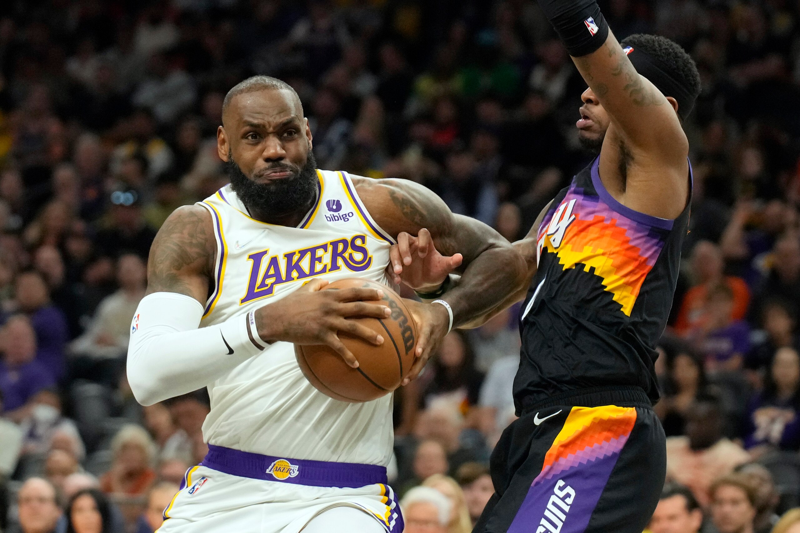 Los Angeles Lakers forward LeBron James, left, drives on Phoenix Suns forward Torrey Craig during the first half of an NBA basketball game, Sunday, March 13, 2022, in Phoenix. (AP Photo/Rick Scuteri) Los Angeles Lakers forward LeBron James, left, drives on Phoenix Suns forward Torrey Craig during the first half of an NBA basketball game, Sunday, March 13, 2022, in Phoenix. (AP Photo/Rick Scuteri)