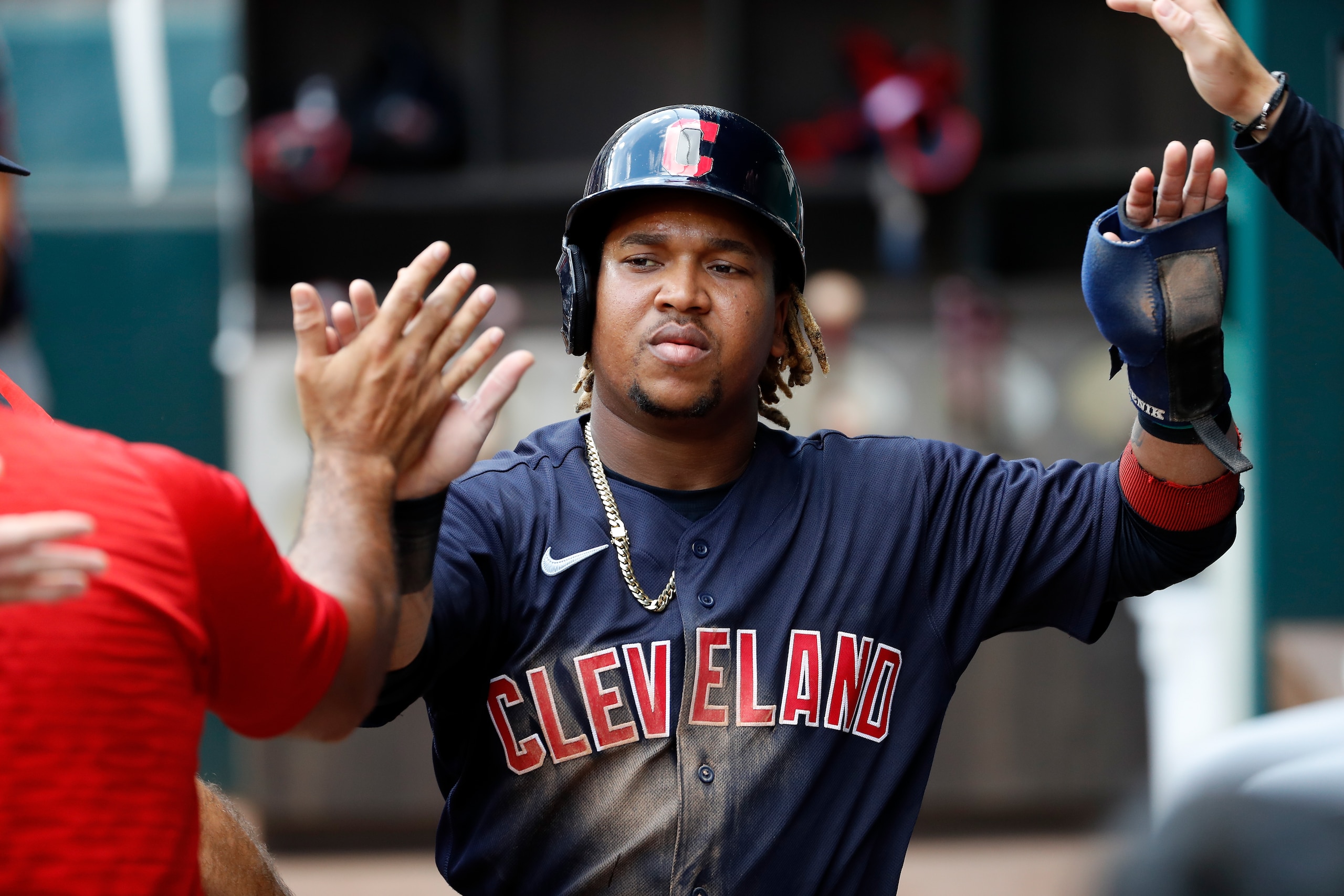 ARLINGTON, TEXAS - OCTOBER 03: Jose Ramirez #11 of the Cleveland Indians is greeted by teammates after scoring a run in the third inning against the Texas Rangers at Globe Life Field on October 03, 2021 in Arlington, Texas. (Photo by Tim Warner/Getty Images)