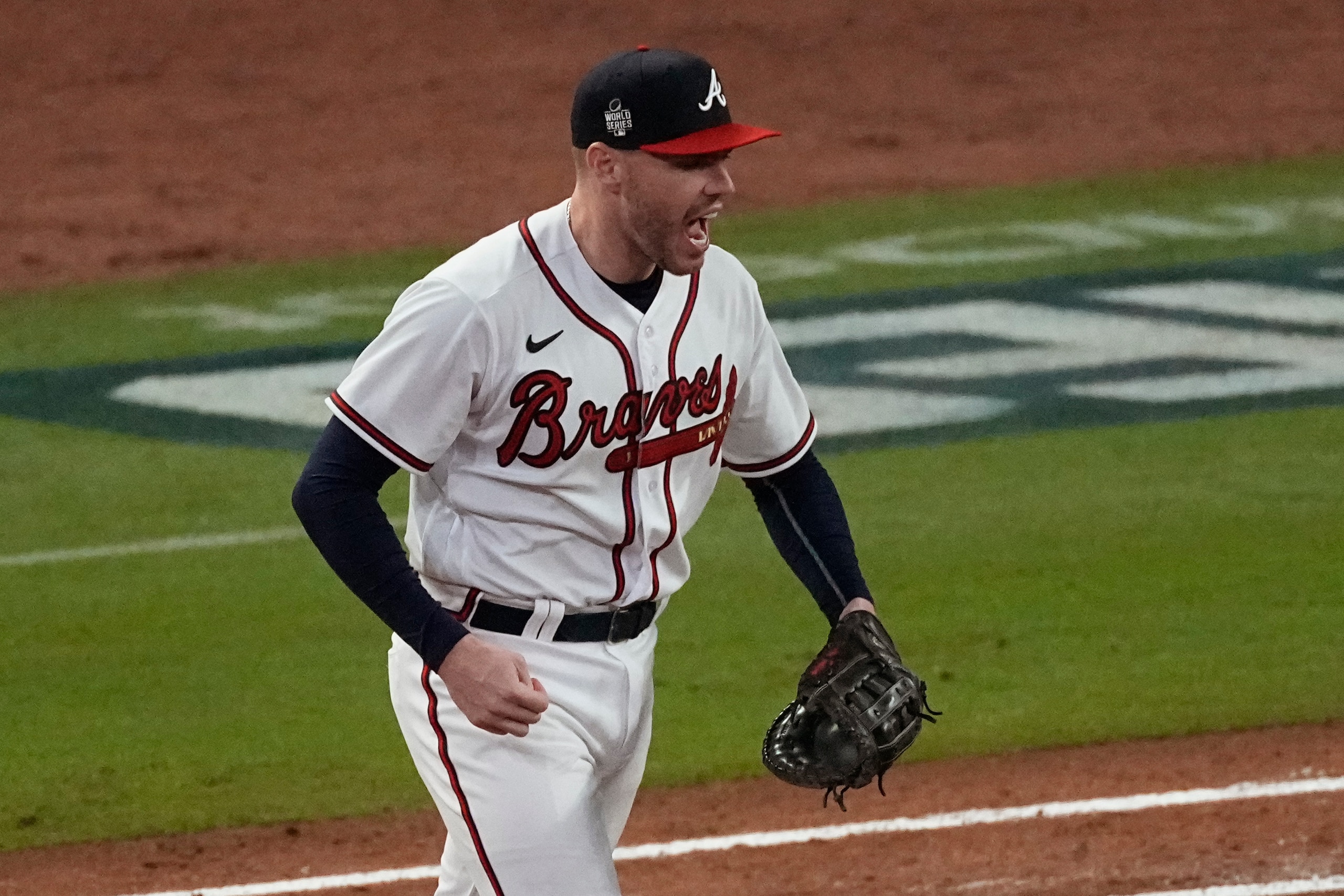 Atlanta Braves first baseman Freddie Freeman celebrates the last out in Game 4 of baseball's World Series between the Houston Astros and the Atlanta Braves Saturday, Oct. 30, 2021, in Atlanta. The Braves won 3-2, to lead the series 3-1 games. (AP Photo/John Bazemore)