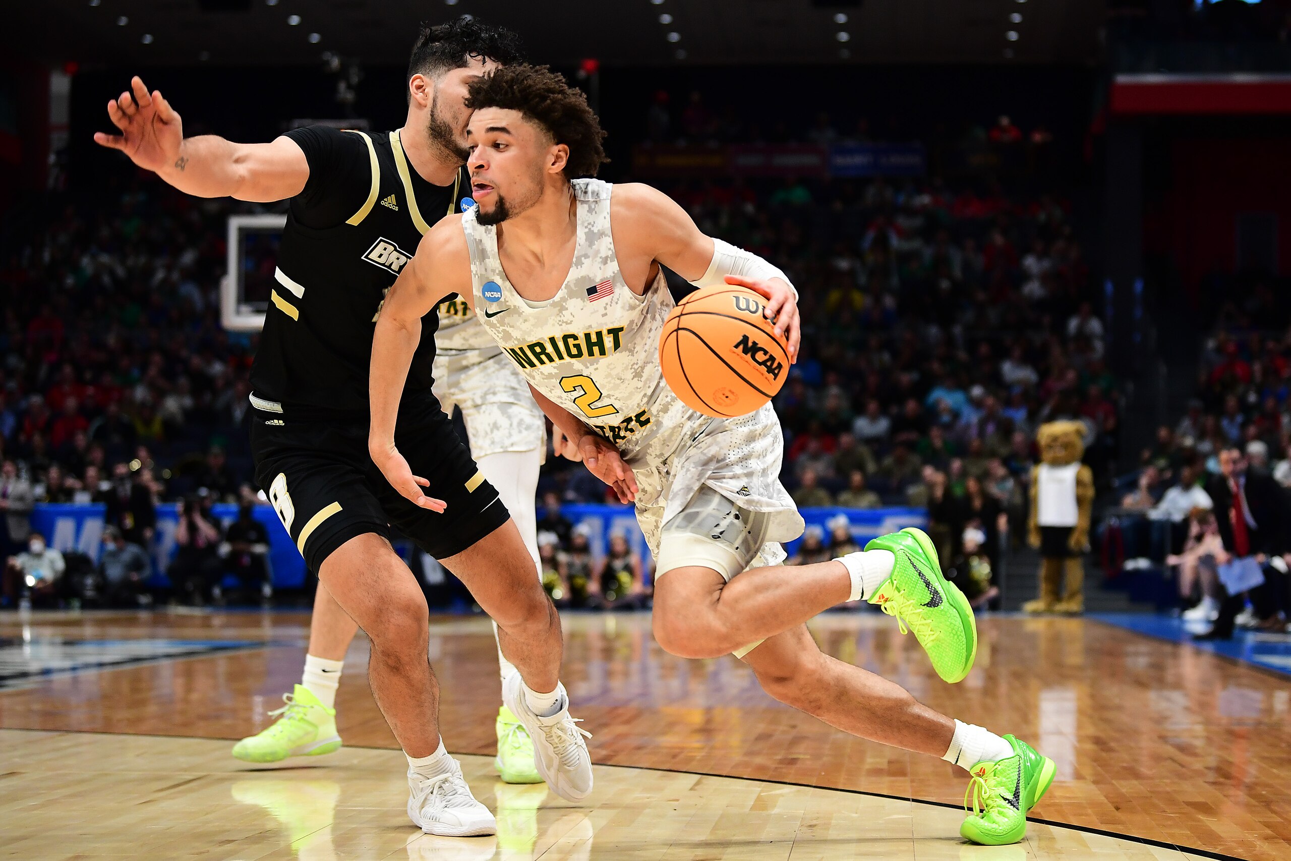DAYTON, OHIO - MARCH 16: Tanner Holden #2 of the Wright State Raiders drives past Luis Hurtado #10 of the Bryant University Bulldogs in the second half of the game during the First Four game of the 2022 NCAA Men's Basketball Tournament at UD Arena on March 16, 2022 in Dayton, Ohio. (Photo by Emilee Chinn/Getty Images)