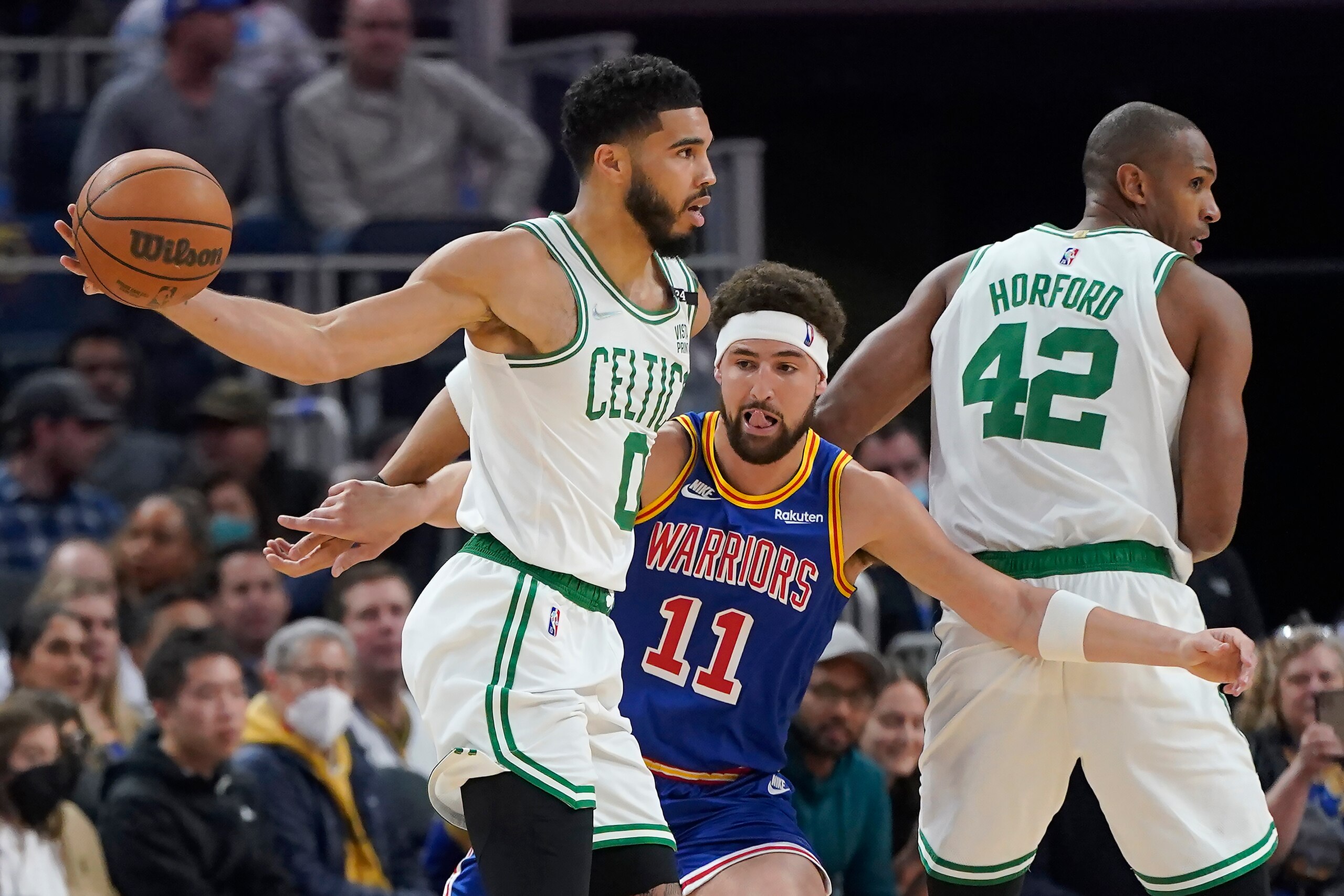 Boston Celtics forward Jayson Tatum, left, is defended by Golden State Warriors guard Klay Thompson during the first half of an NBA basketball game in San Francisco, Wednesday, March 16, 2022. (AP Photo/Jeff Chiu)