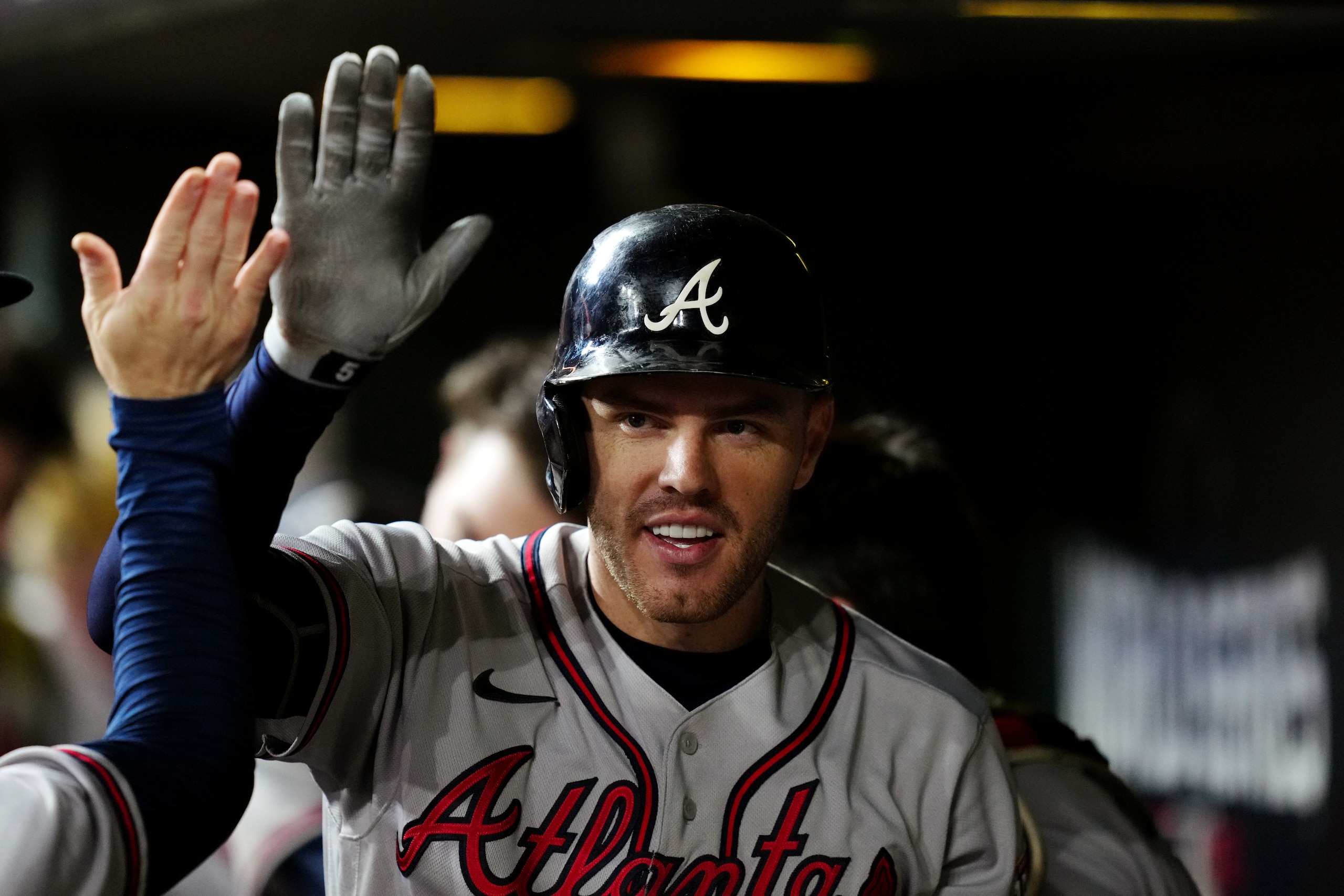 HOUSTON, TX - NOVEMBER 02:  Freddie Freeman #5 of the Atlanta Braves is greeted in the dugout after hitting a solo home run in the seventh inning during Game 6 of the 2021 World Series between the Atlanta Braves and the Houston Astros at Minute Maid Park on Tuesday, November 2, 2021 in Houston, Texas. (Photo by Daniel Shirey/MLB Photos via Getty Images)