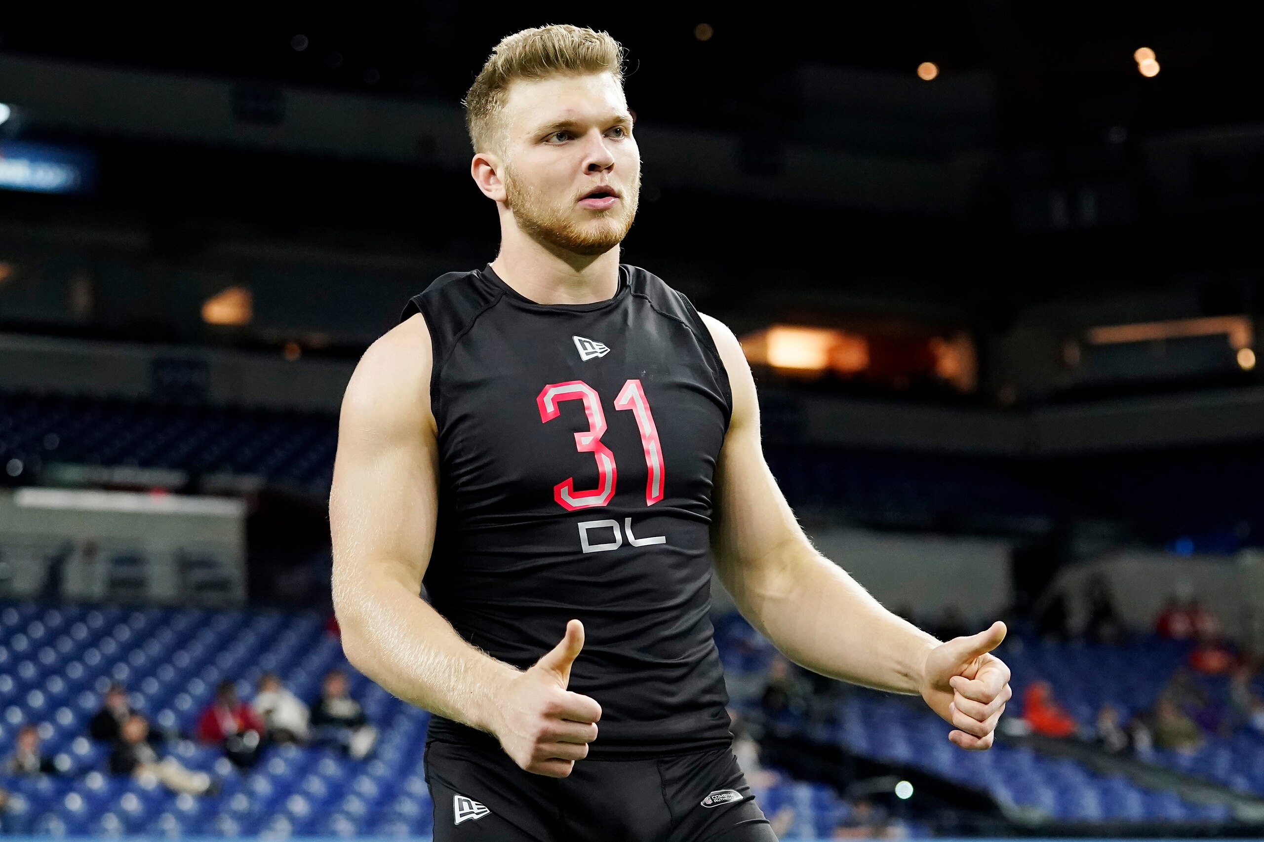 Michigan defensive lineman Aidan Hutchinson (31) reacts after participating in a drill at the NFL football scouting combine in Indianapolis, Saturday, March 5, 2022. (AP Photo/Steve Luciano) Michigan defensive lineman Aidan Hutchinson (31) reacts after participating in a drill at the NFL football scouting combine in Indianapolis, Saturday, March 5, 2022. (AP Photo/Steve Luciano)