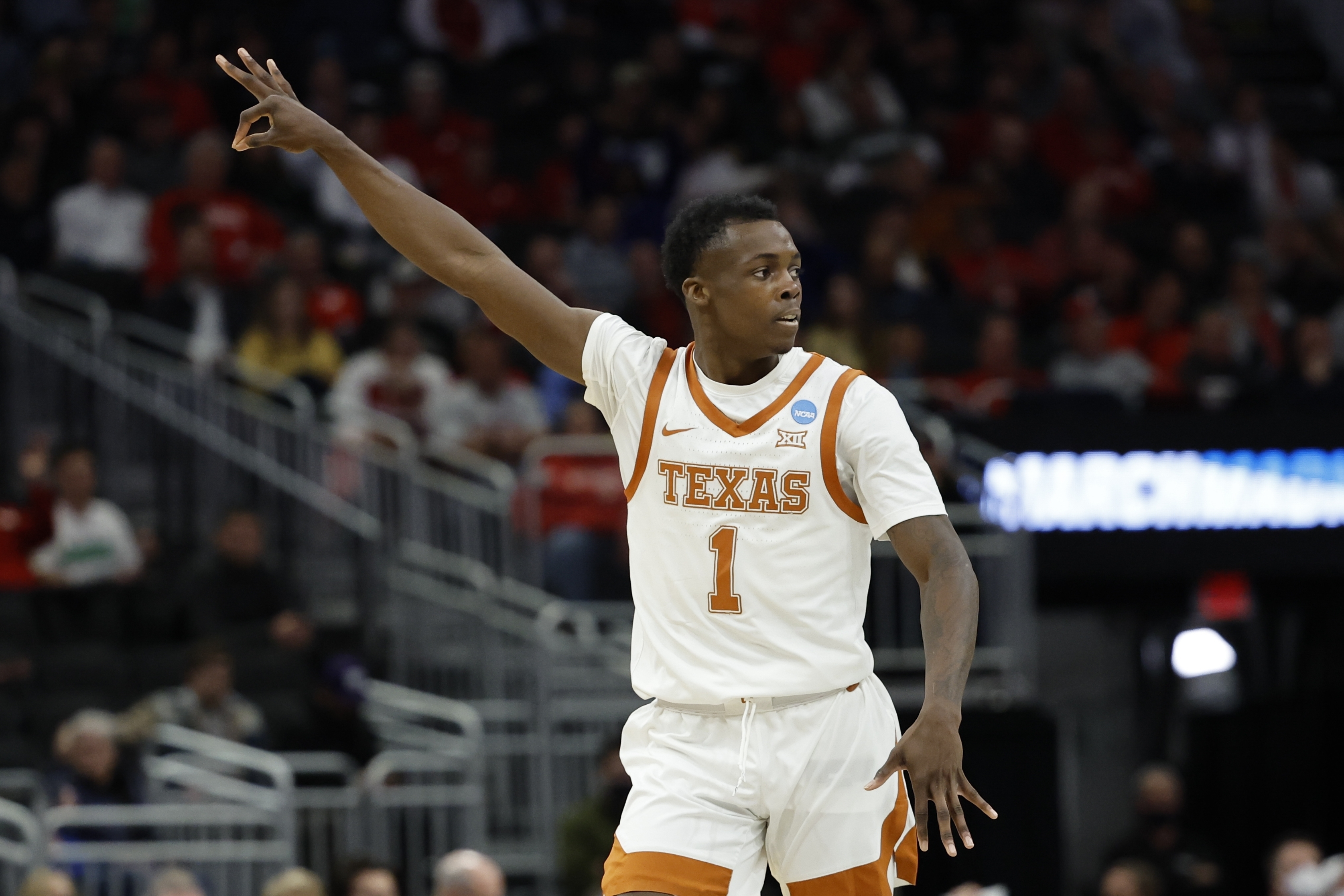 Texas's Andrew Jones recats after making a three-point basket during the first half of a first round NCAA college basketball tournament game against Virginia Tech Friday, March 18, 2022, in Milwaukee. (AP Photo/Jeffrey Phelps)