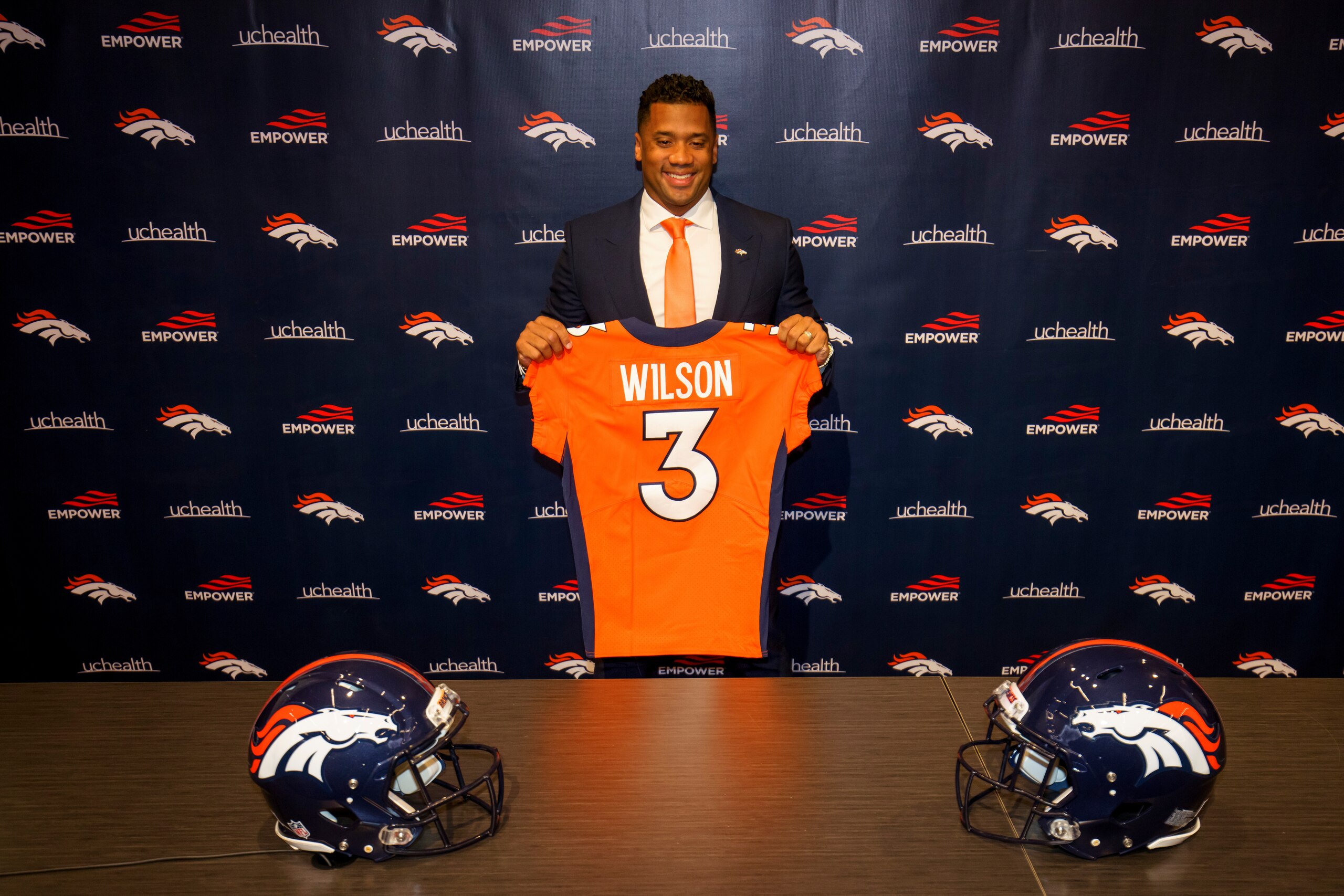 ENGLEWOOD, CO - MARCH 16:  Quarterback Russell Wilson #3 of the Denver Broncos poses with his jersey after speaking to the media at UCHealth Training Center on March 16, 2022 in Englewood, Colorado. (Photo by Justin Edmonds/Getty Images)