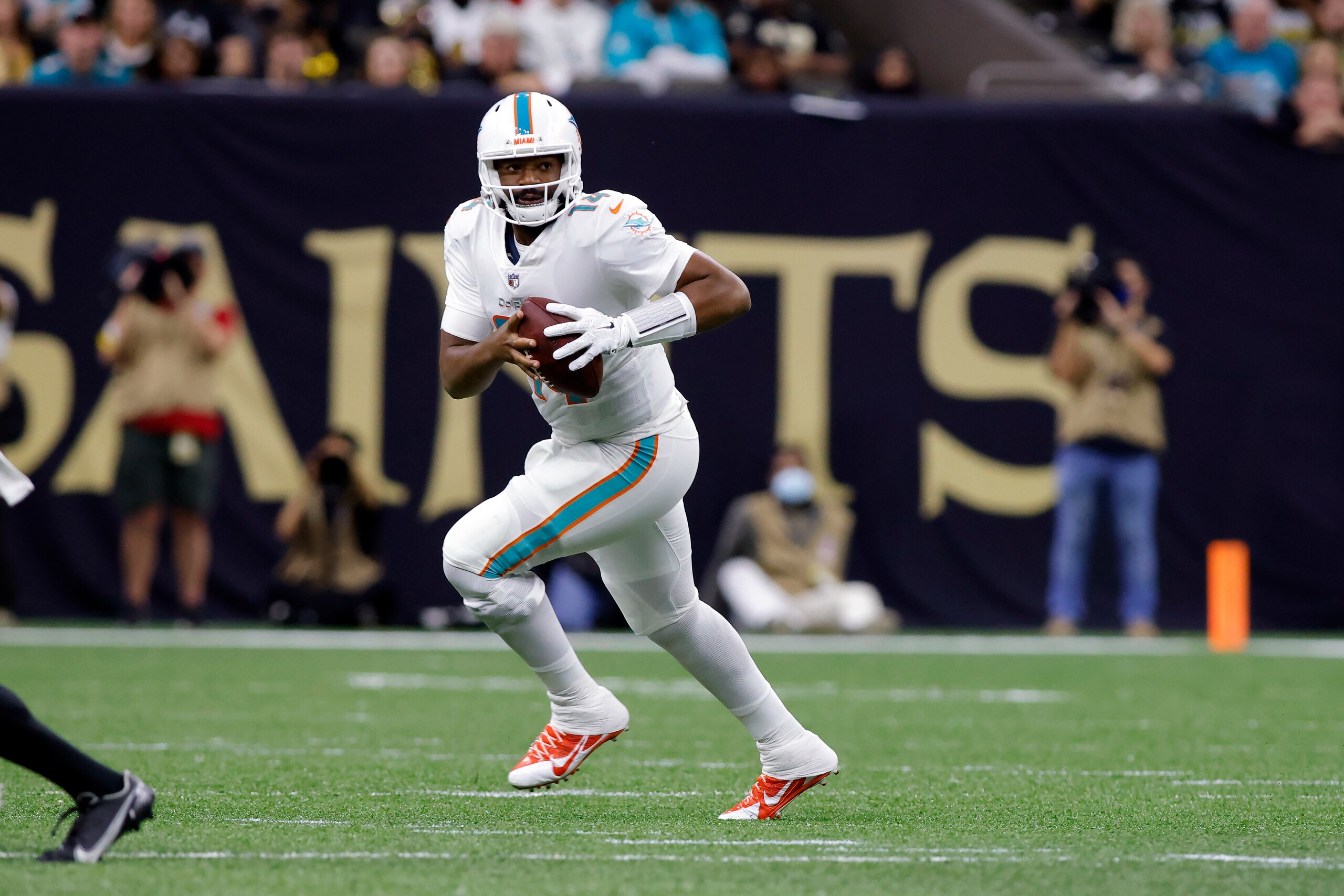 Miami Dolphins quarterback Jacoby Brissett (14) runs the ball during an NFL football game against the New Orleans Saints, Monday, Dec. 27, 2021, in New Orleans. (AP Photo/Tyler Kaufman)