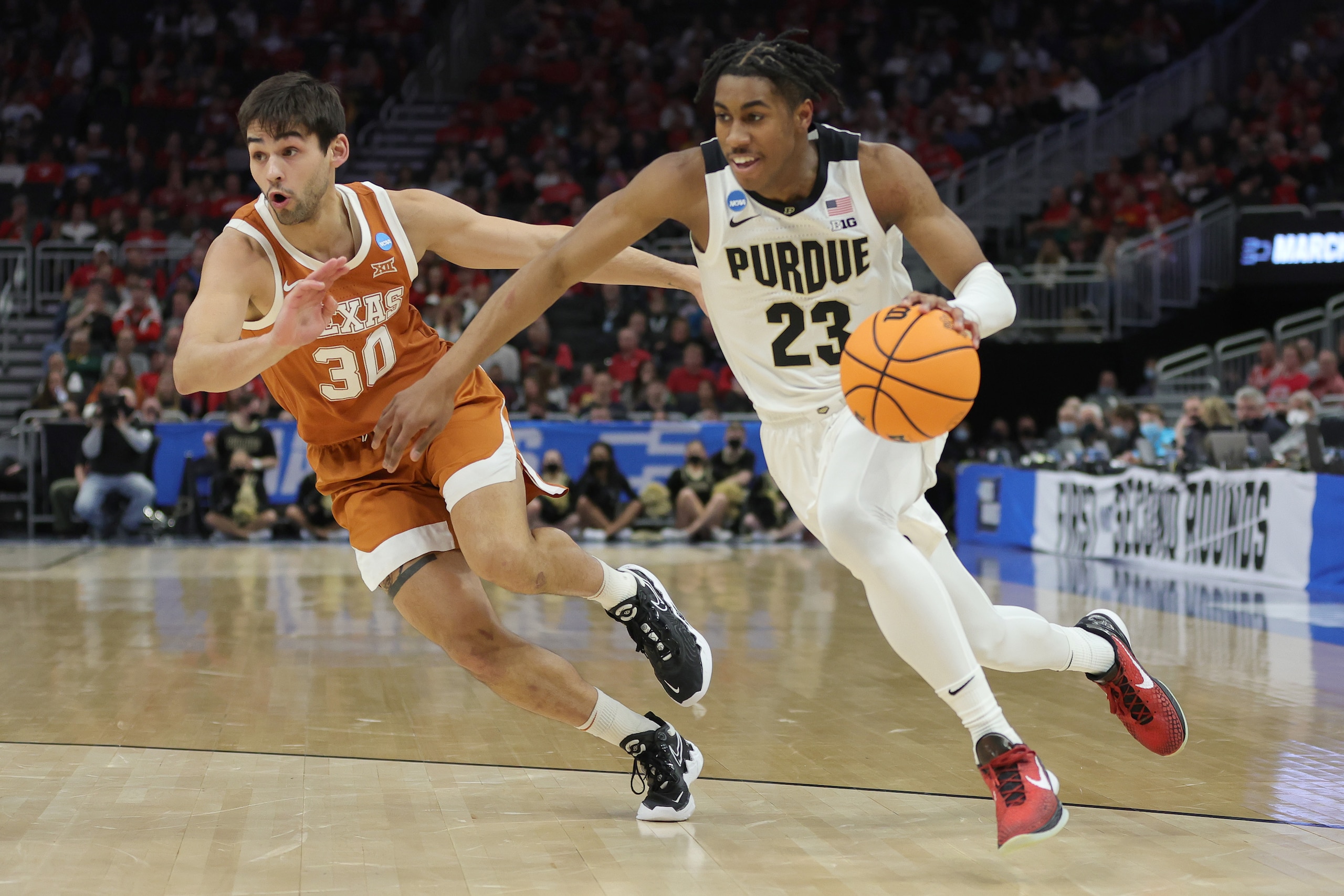 MILWAUKEE, WISCONSIN - MARCH 20: Jaden Ivey #23 of the Purdue Boilermakers dribbles the ball passed Brock Cunningham #30 of the Texas Longhorns during the first half in the second round of the 2022 NCAA Men's Basketball Tournament at Fiserv Forum on March 20, 2022 in Milwaukee, Wisconsin. (Photo by Stacy Revere/Getty Images)