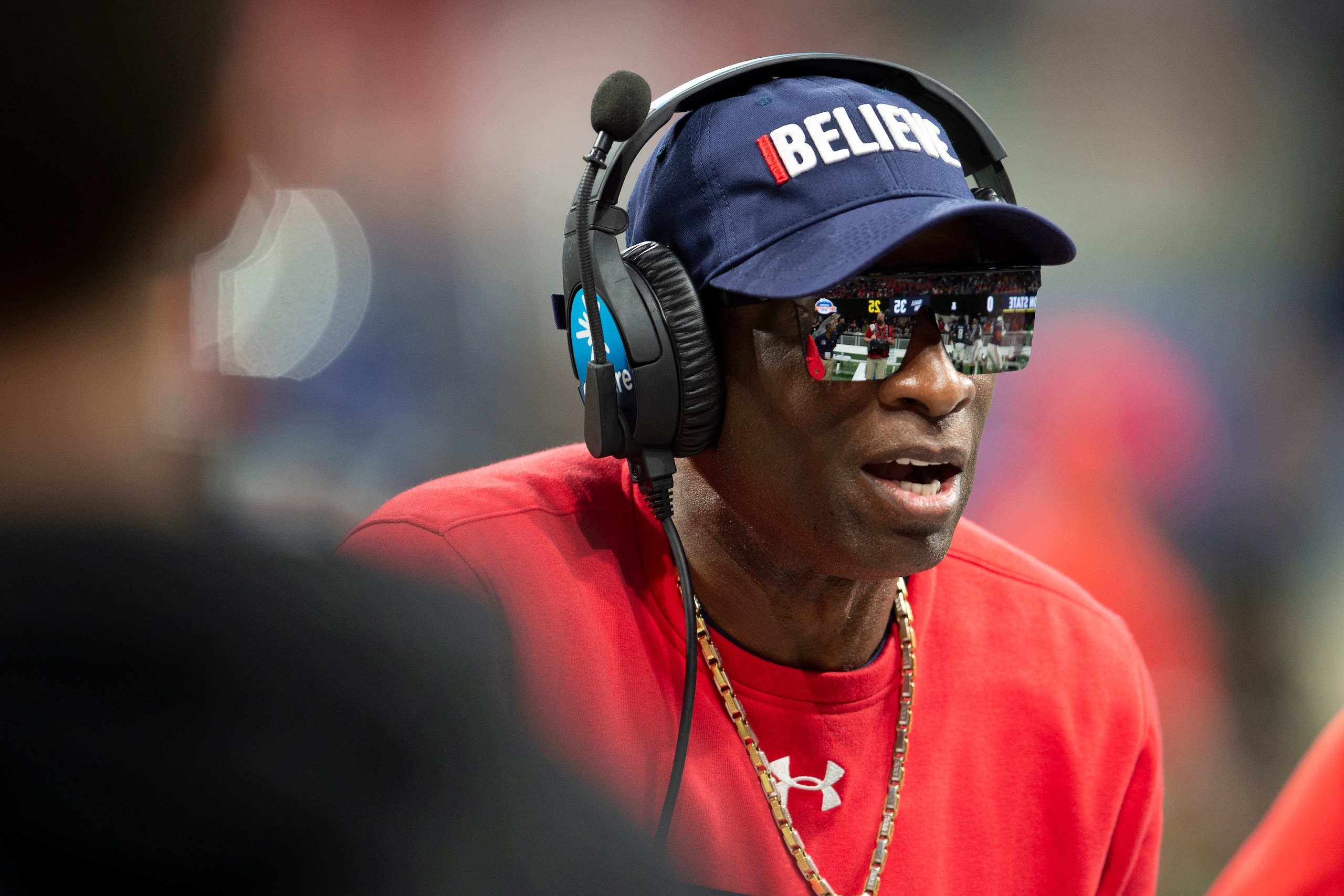 Jackson State head coach Deion Sanders speaking with team during the first half of the Cricket Celebration Bowl NCAA college football game against the South Carolina State Saturday, Dec. 18, 2021, in Atlanta. (AP Photo/Hakim Wright Sr.)