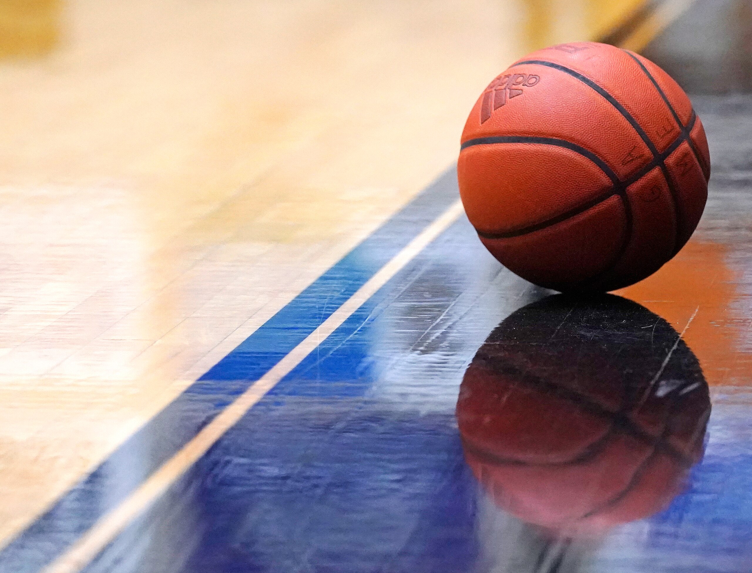 An Adidas basketball on the court during the Northeast Conference men's NCAA college basketball championship game, Tuesday, March 8, 2022, in Smithfield, R.I. (AP Photo/Charles Krupa)
