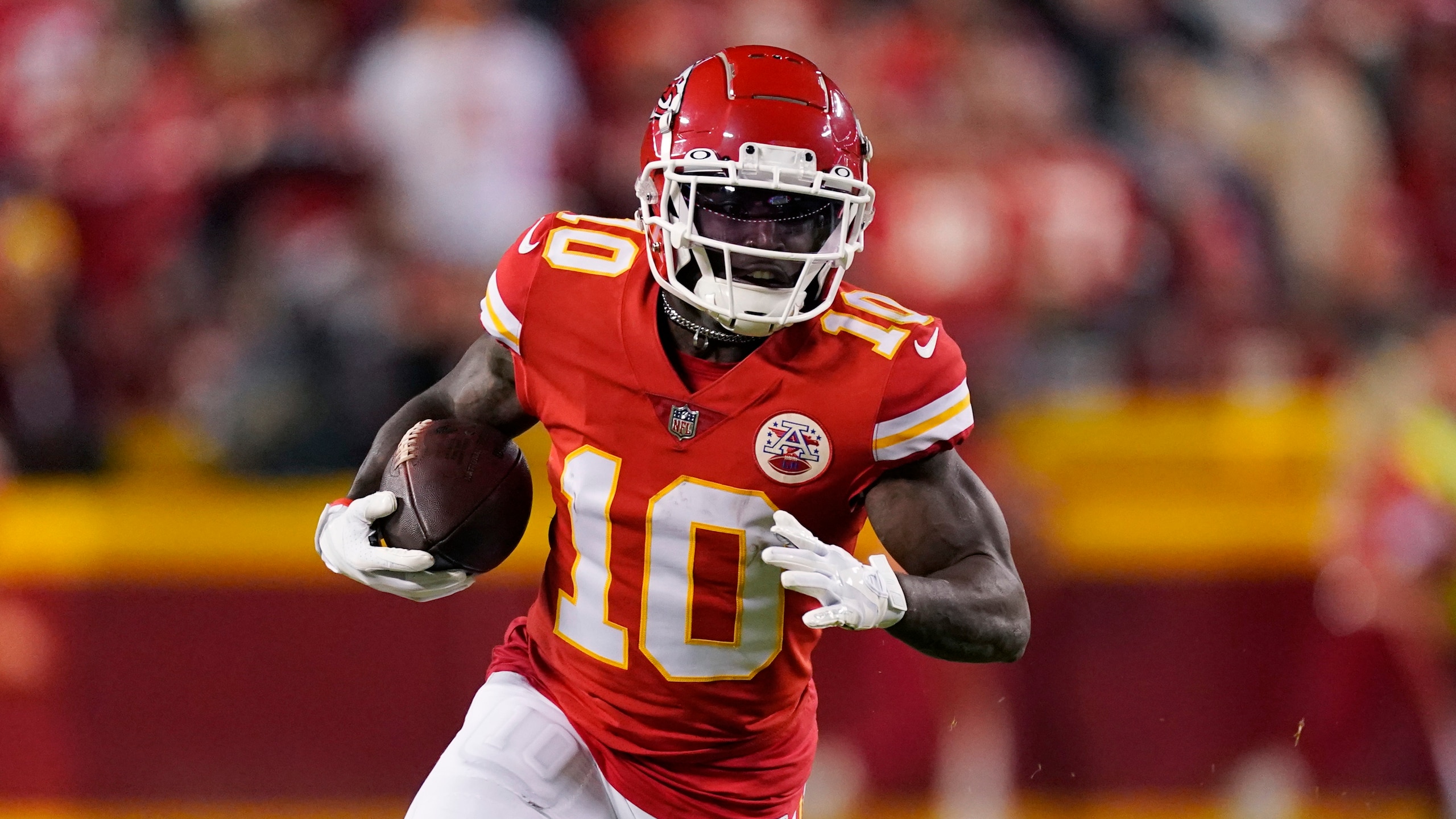 Kansas City Chiefs wide receiver Tyreek Hill (10) runs up field during the first half of an NFL divisional round playoff football game against the Buffalo Bills, Sunday, Jan. 23, 2022, in Kansas City, Mo. (AP Photo/Charlie Riedel)