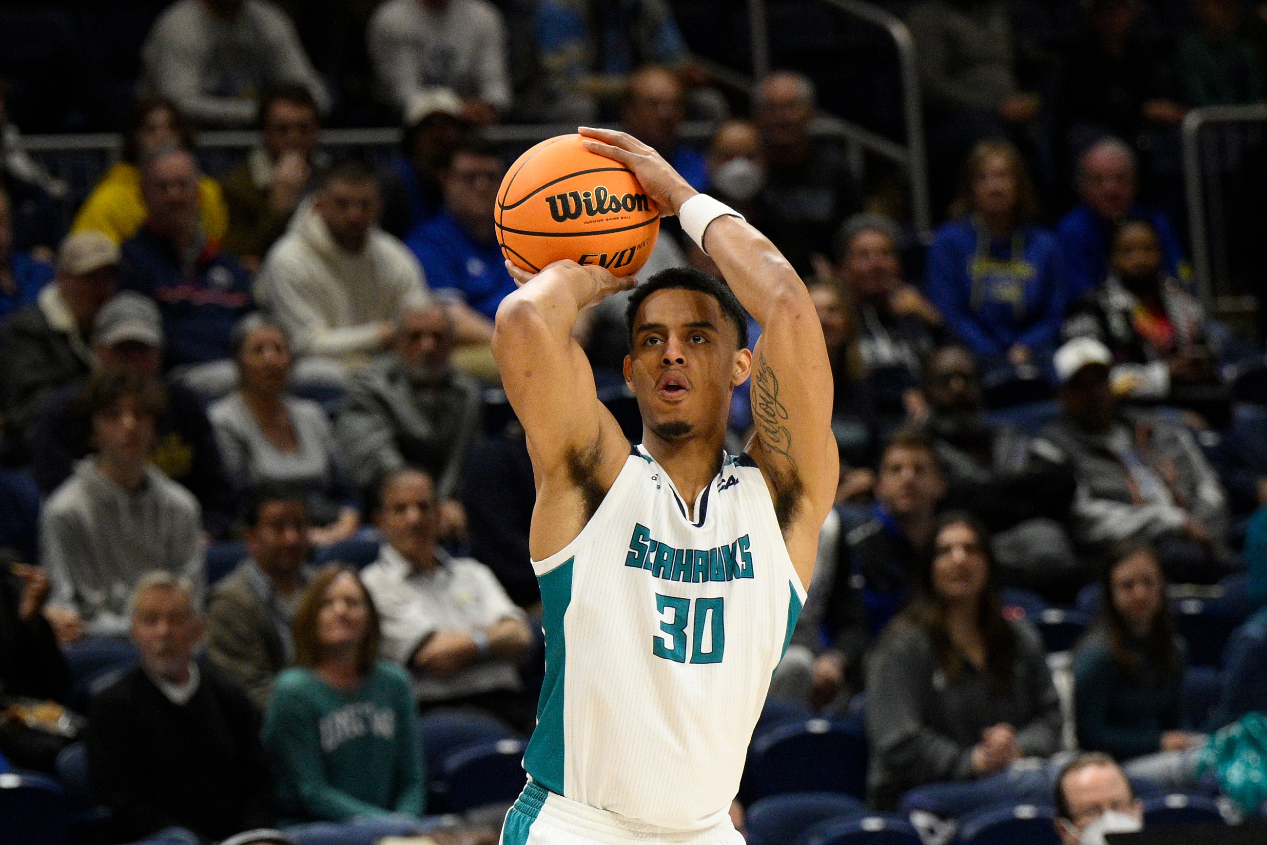 UNC Wilmington guard Jaylen Sims (30) in action during the first half of an NCAA college basketball game in the championship of the Colonial Athletic Association conference tournament against Delaware, Tuesday, March 8, 2022, in Washington. (AP Photo/Nick Wass)