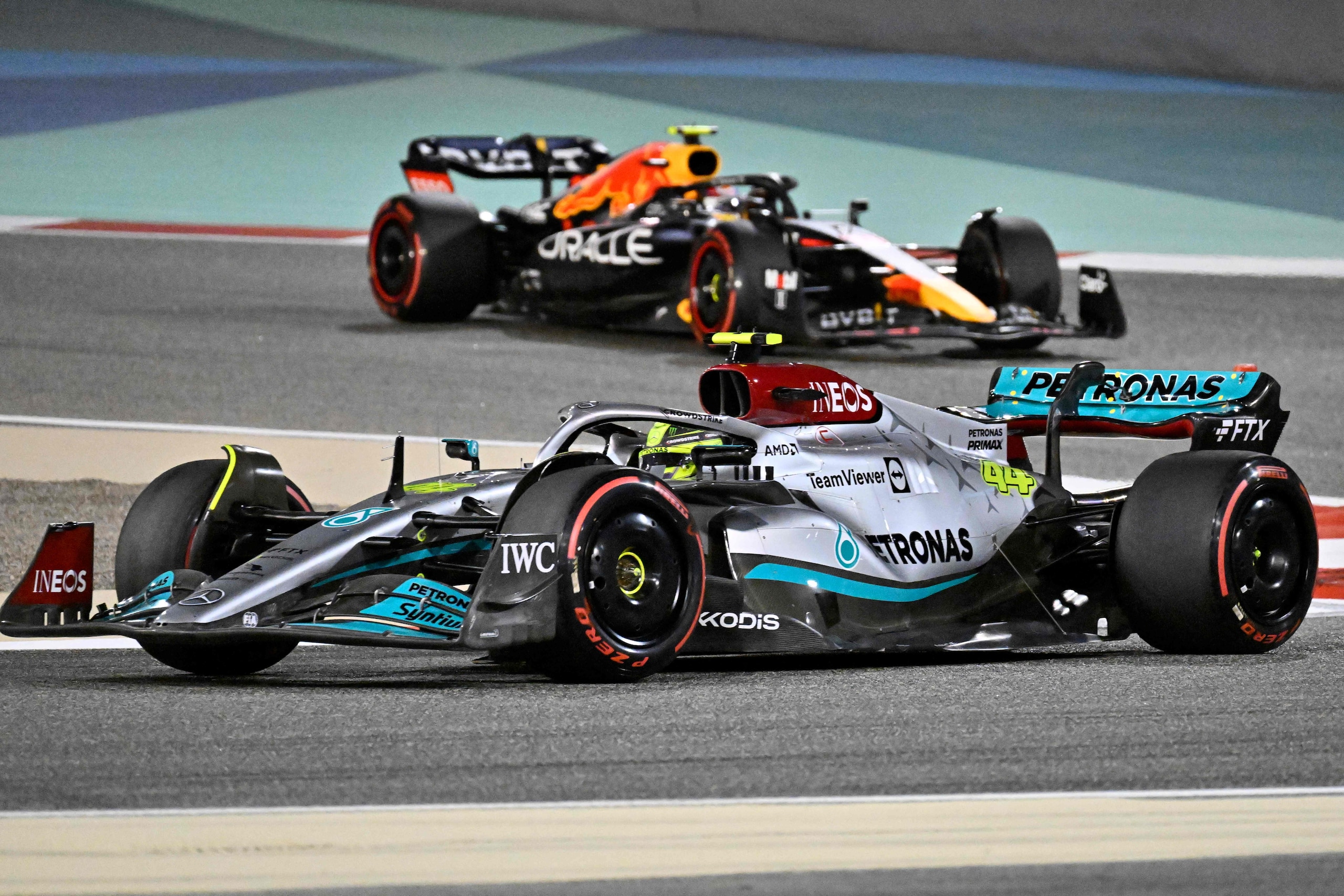 Mercedes' British driver Lewis Hamilton (foreground) and Red Bull's Mexican driver Sergio Perez (background) drive during the Bahrain Formula One Grand Prix at the Bahrain International Circuit in the city of Sakhir on March 20, 2022. (Photo by Mazen MAHDI / AFP) (Photo by MAZEN MAHDI/AFP via Getty Images)