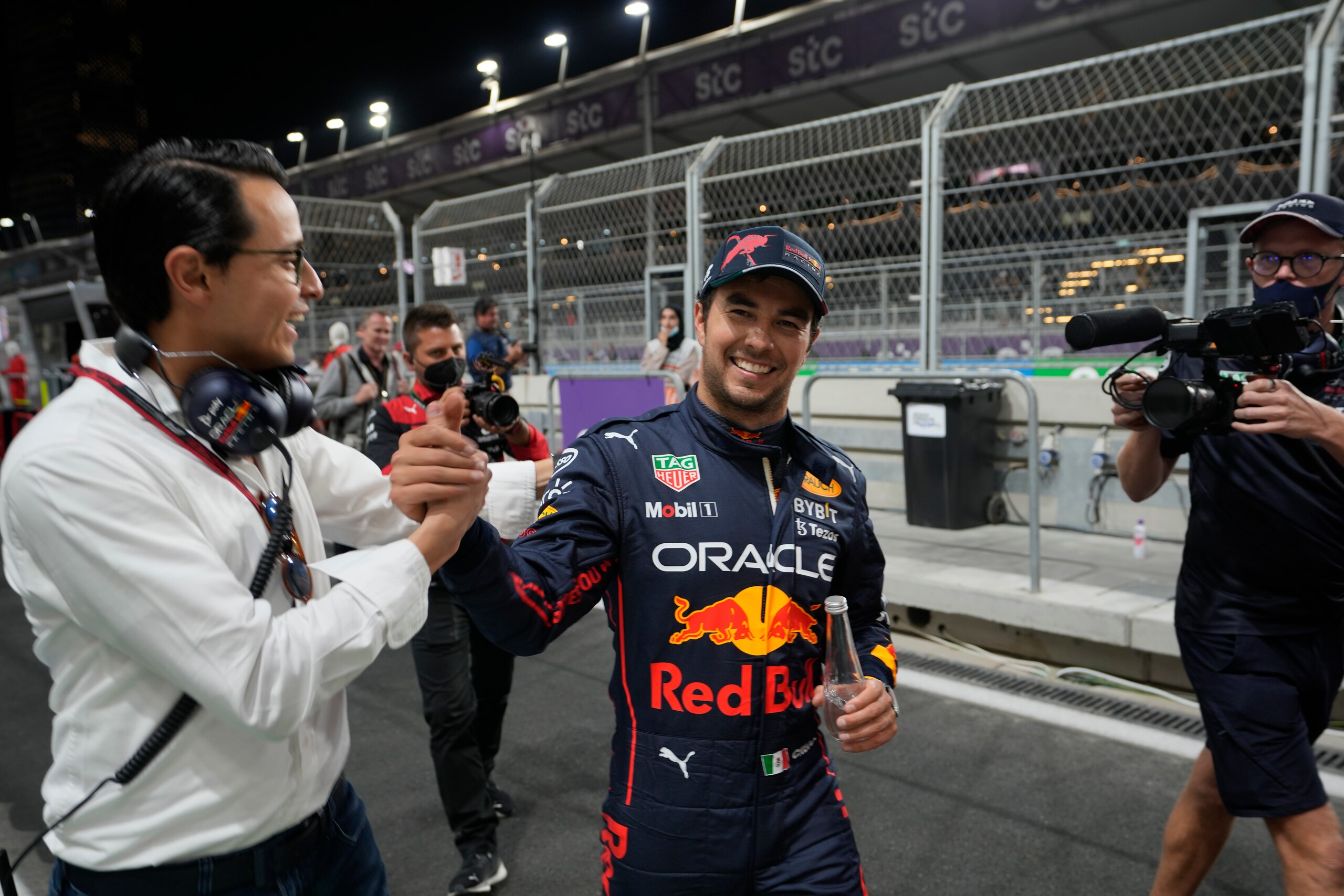 Red Bull driver Sergio Perez of Mexico reacts after winning pole position at the Formula One Grand Prix it in Jiddah, Saudi Arabia, Saturday, March 26, 2022. (AP Photo/Hassan Ammar)