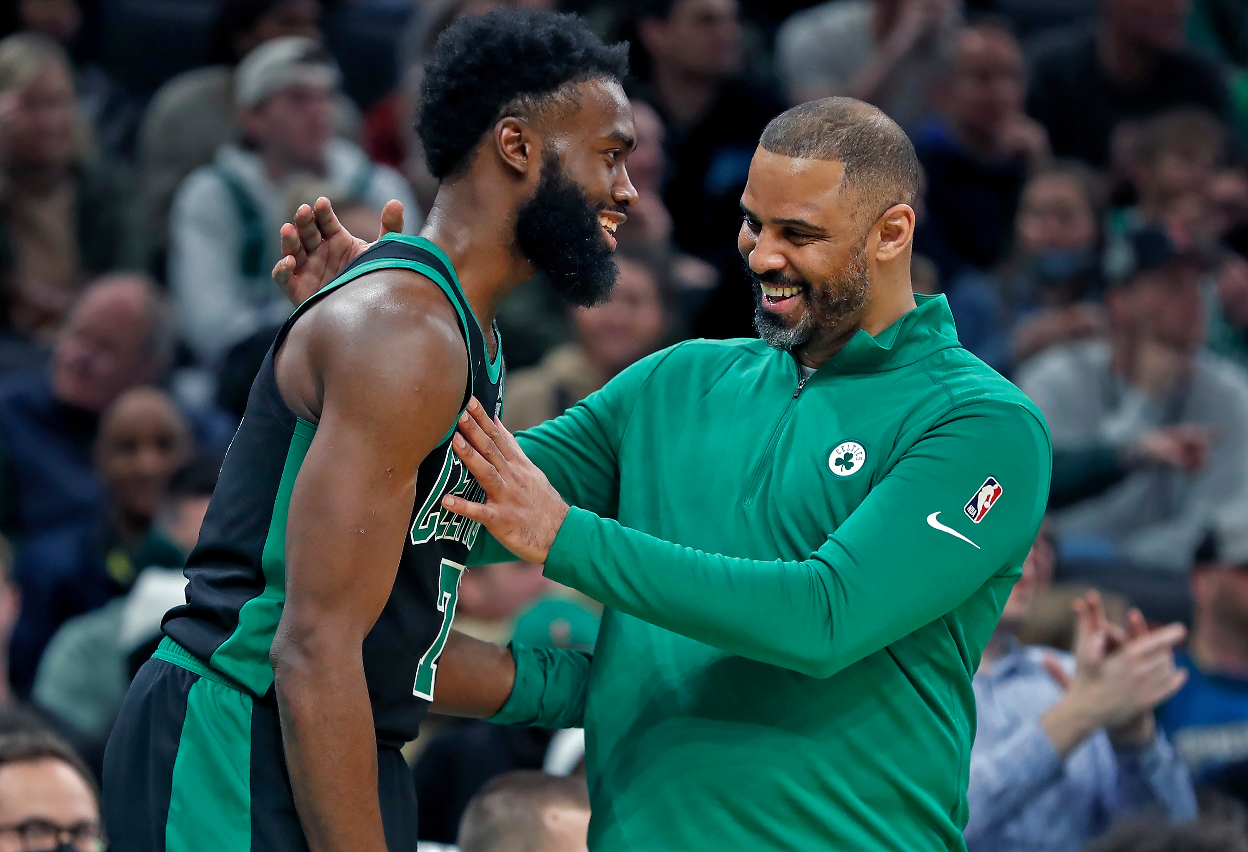 Boston - March 27: The Celtics romped over the Timberwolves, and as the game was safely in the books in the fourth quarter, head coach Ime Udoka (right) had a big smile and a pat for a smiling Jaylen Brown (left) on the sidelines. The Boston Celtics hosted the Minnesota Timberwolves in a regular season NBA basketball game at the TD Garden in Boston on March 27, 2022. (Photo by Jim Davis/The Boston Globe via Getty Images)