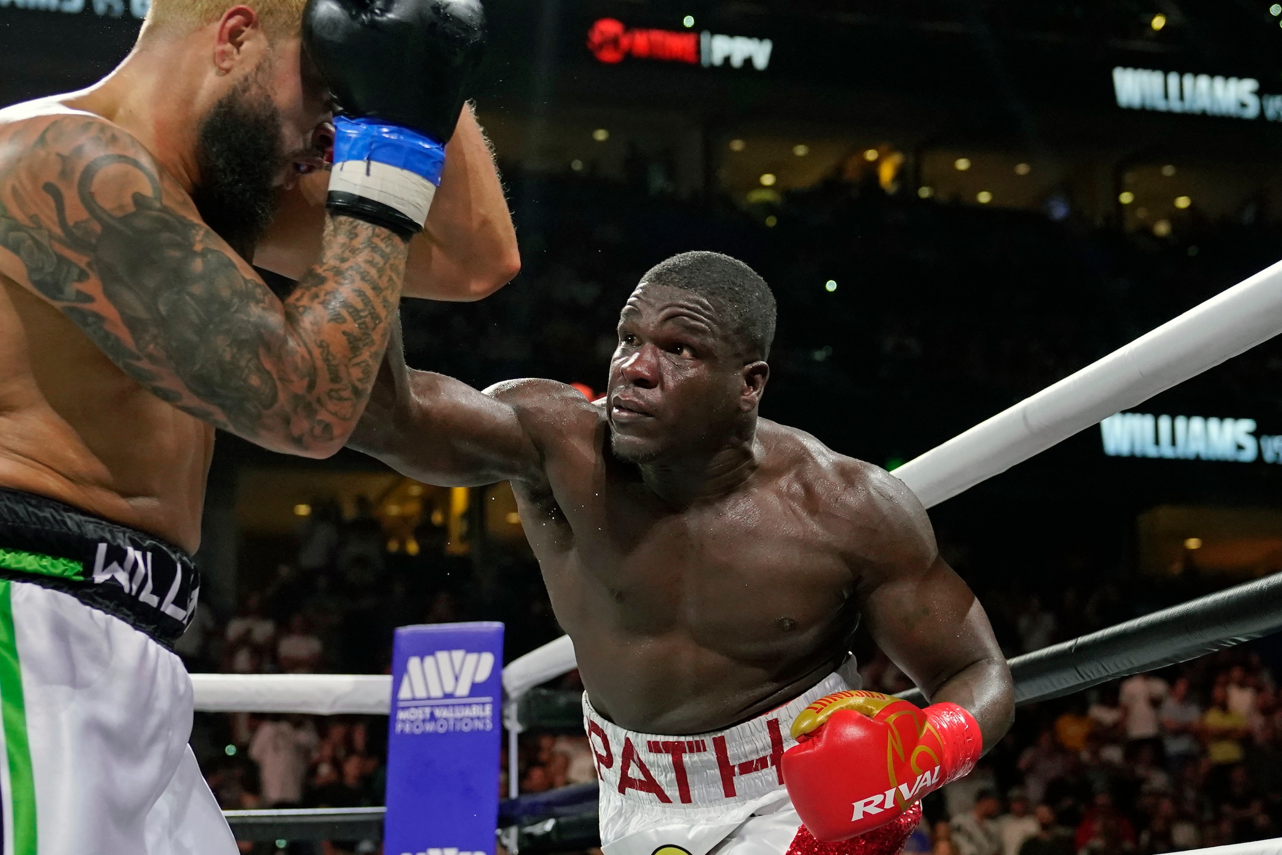 Deron Williams, left, and Frank Gore box during the fourth round of a heavyweight special attraction fight Saturday, Dec. 18, 2021, in Tampa, Fla. (AP Photo/Chris O'Meara)