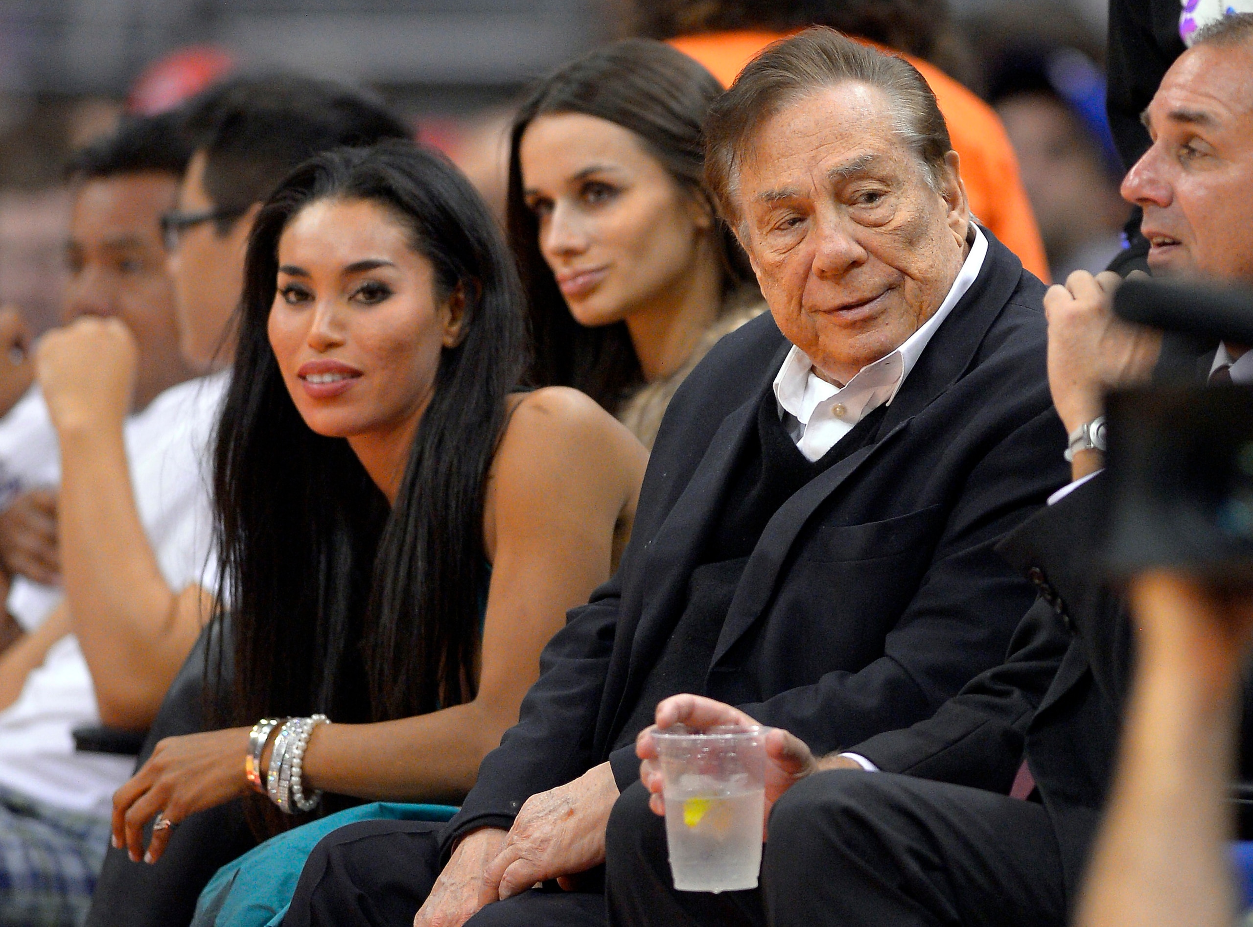 FILE - In this Oct. 25, 2013, file photo, then-Los Angeles Clippers owner Donald Sterling, right, and V. Stiviano, left, watch the Clippers play the Sacramento Kings during an NBA basketball game in Los Angeles. Former Billionaire Donald Sterling has dropped his lawsuit against a former female friend over the recording of his off-color remarks that cost him ownership of the Los Angeles Clippers. A Los Angeles County judge dismissed the lawsuit against V. Stiviano on Wednesday at Sterling's request. (AP Photo/Mark J. Terrill, File) FILE - In this Oct. 25, 2013, file photo, then-Los Angeles Clippers owner Donald Sterling, right, and V. Stiviano, left, watch the Clippers play the Sacramento Kings during an NBA basketball game in Los Angeles. Former Billionaire Donald Sterling has dropped his lawsuit against a former female friend over the recording of his off-color remarks that cost him ownership of the Los Angeles Clippers. A Los Angeles County judge dismissed the lawsuit against V. Stiviano on Wednesday at Sterling's request. (AP Photo/Mark J. Terrill, File)