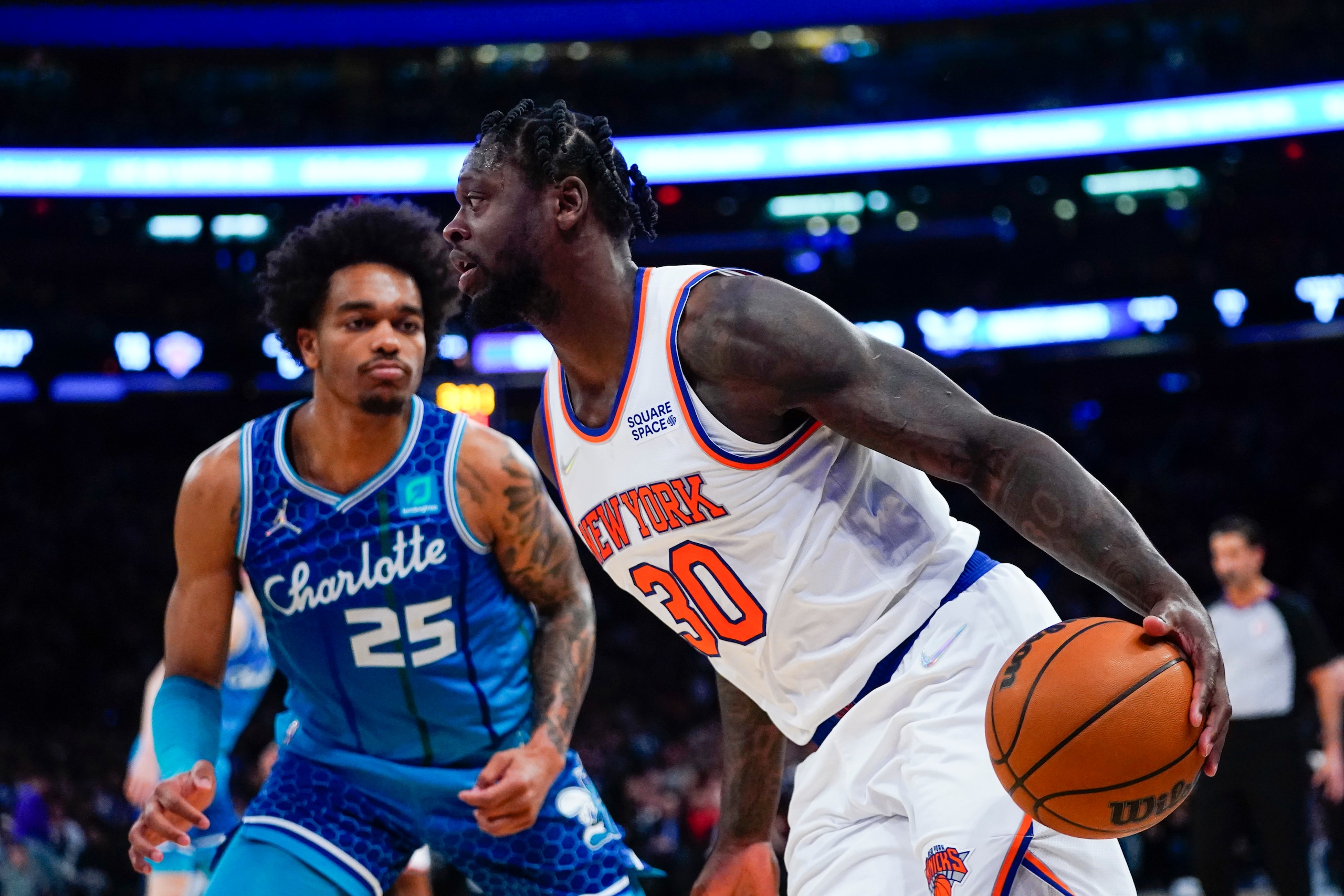 New York Knicks' Julius Randle (30) drives past Charlotte Hornets' P.J. Washington (25) during the second half of an NBA basketball game Wednesday, March 30, 2022, in New York. (AP Photo/Frank Franklin II)