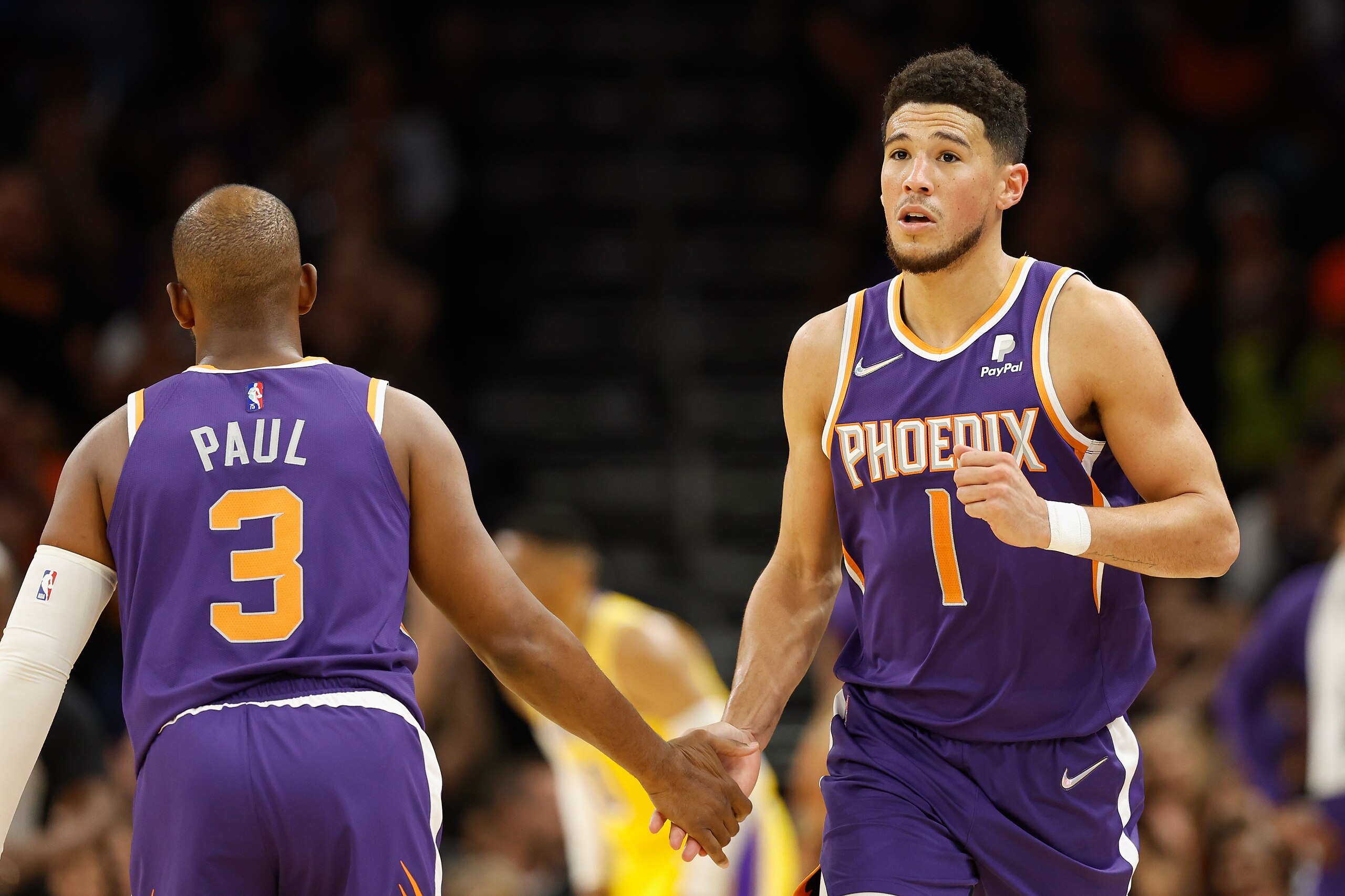 PHOENIX, ARIZONA - APRIL 05: Devin Booker #1 of the Phoenix Suns high fives Chris Paul #3 after a three-point shot against the Los Angeles Lakers during the first half of the NBA game at Footprint Center on April 05, 2022 in Phoenix, Arizona.  NOTE TO USER: User expressly acknowledges and agrees that, by downloading and or using this photograph, User is consenting to the terms and conditions of the Getty Images License Agreement. (Photo by Christian Petersen/Getty Images)