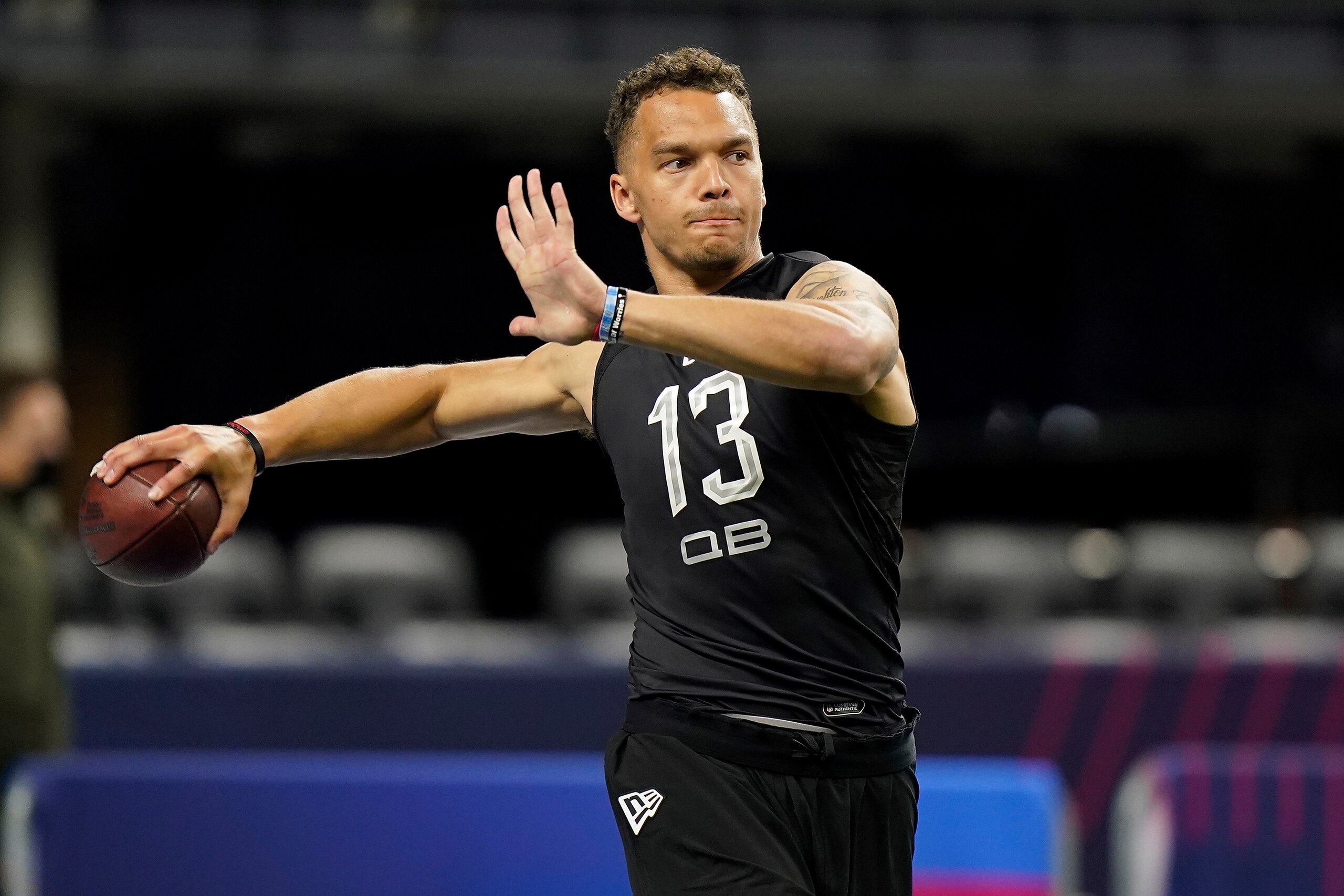 Cincinnati quarterback Desmond Ridder (13) warms up at the NFL football scouting combine in Indianapolis, Thursday, March 3, 2022. (AP Photo/Steve Luciano)