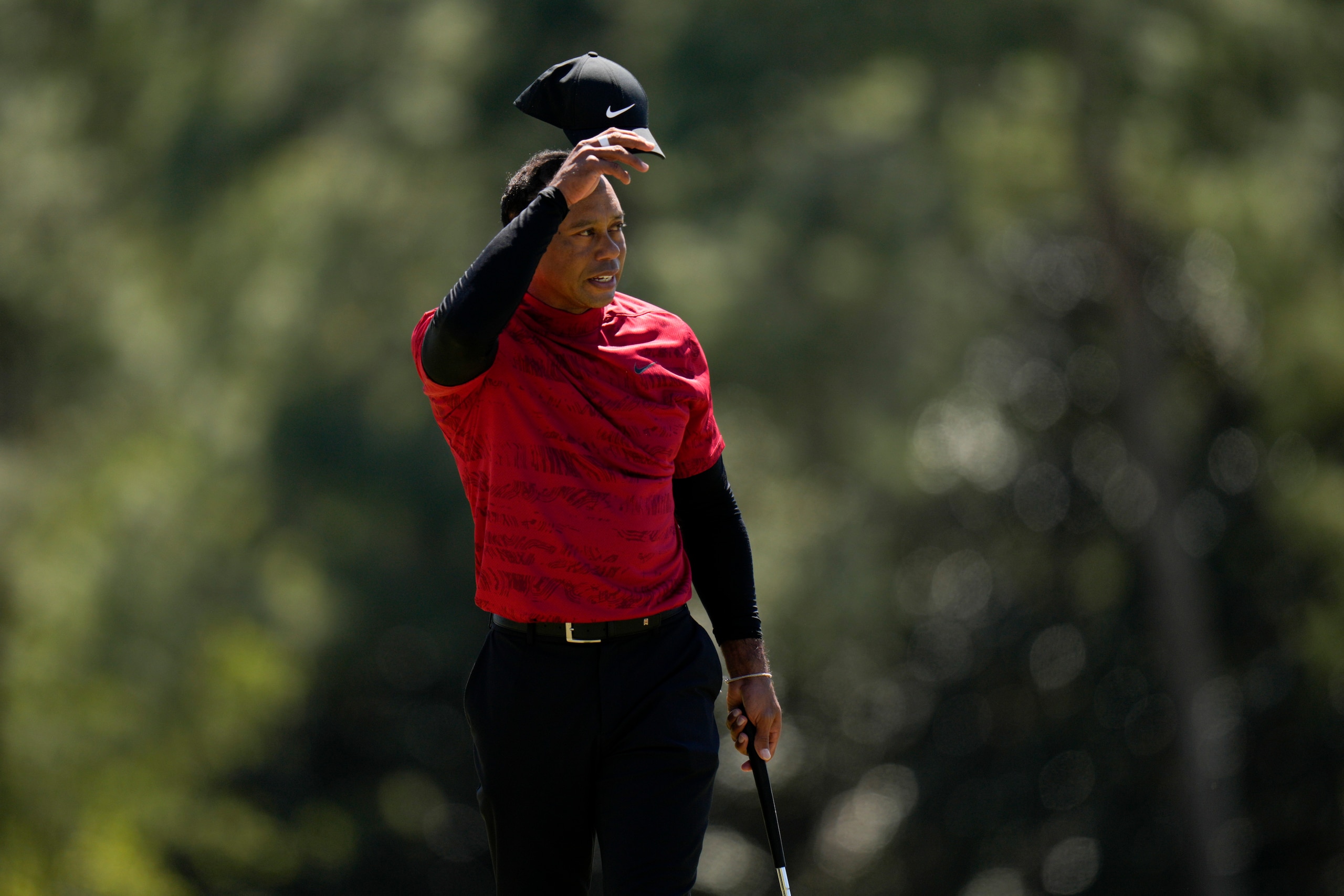 Tiger Woods tips his cap on the 18th hole during the final round at the Masters golf tournament on Sunday, April 10, 2022, in Augusta, Ga. (AP Photo/Jae C. Hong)