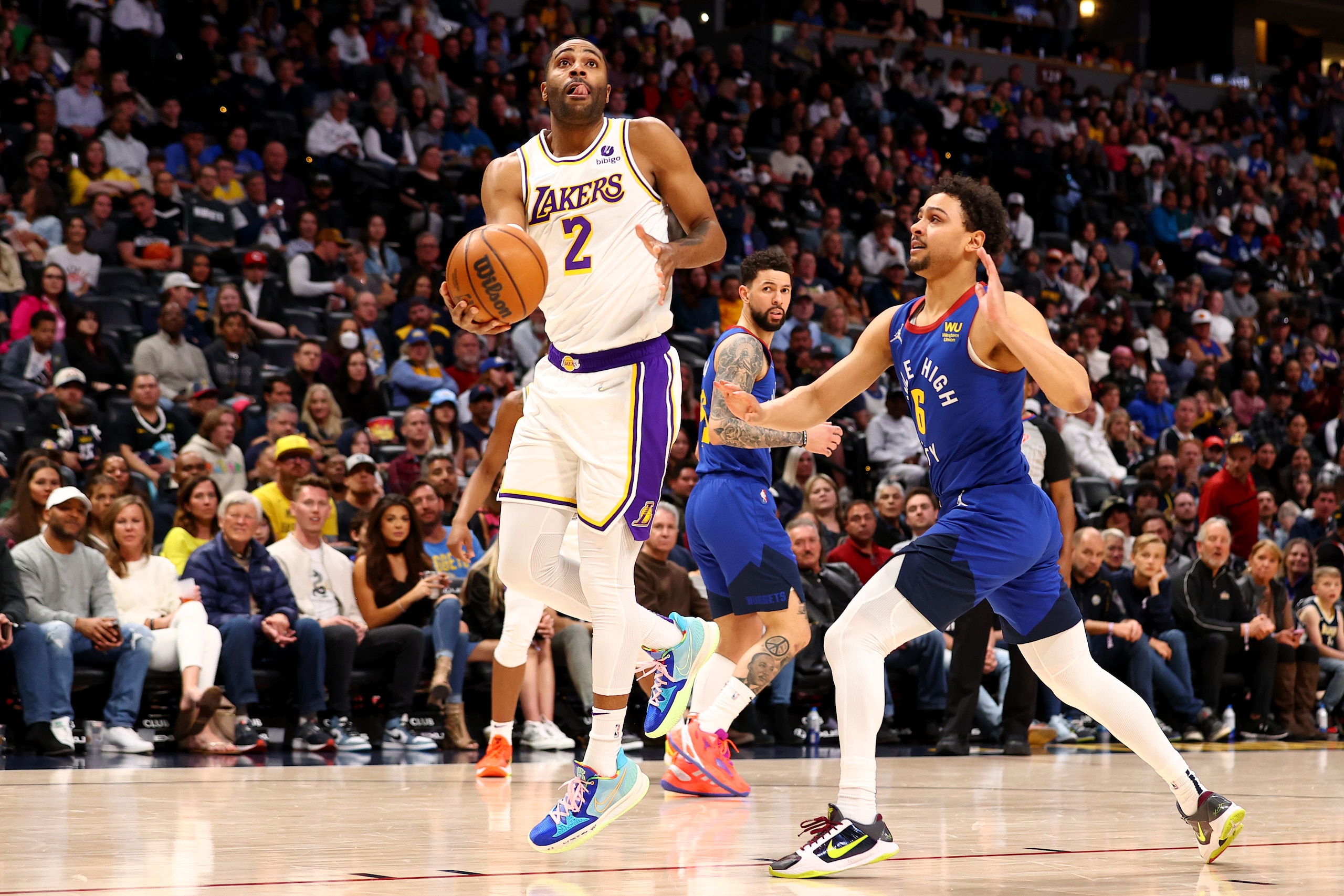 DENVER, CO - APRIL 10: Wayne Ellington #2 of the Los Angeles Lakers  drives past Bryn Forbes #6 of the Denver Nuggets at Ball Arena on April 10, 2022 in Denver, Colorado. NOTE TO USER: User expressly acknowledges and agrees that,  by downloading and or using this photograph,  User is consenting to the terms and conditions of the Getty Images License Agreement. (Photo by Jamie Schwaberow/Getty Images)