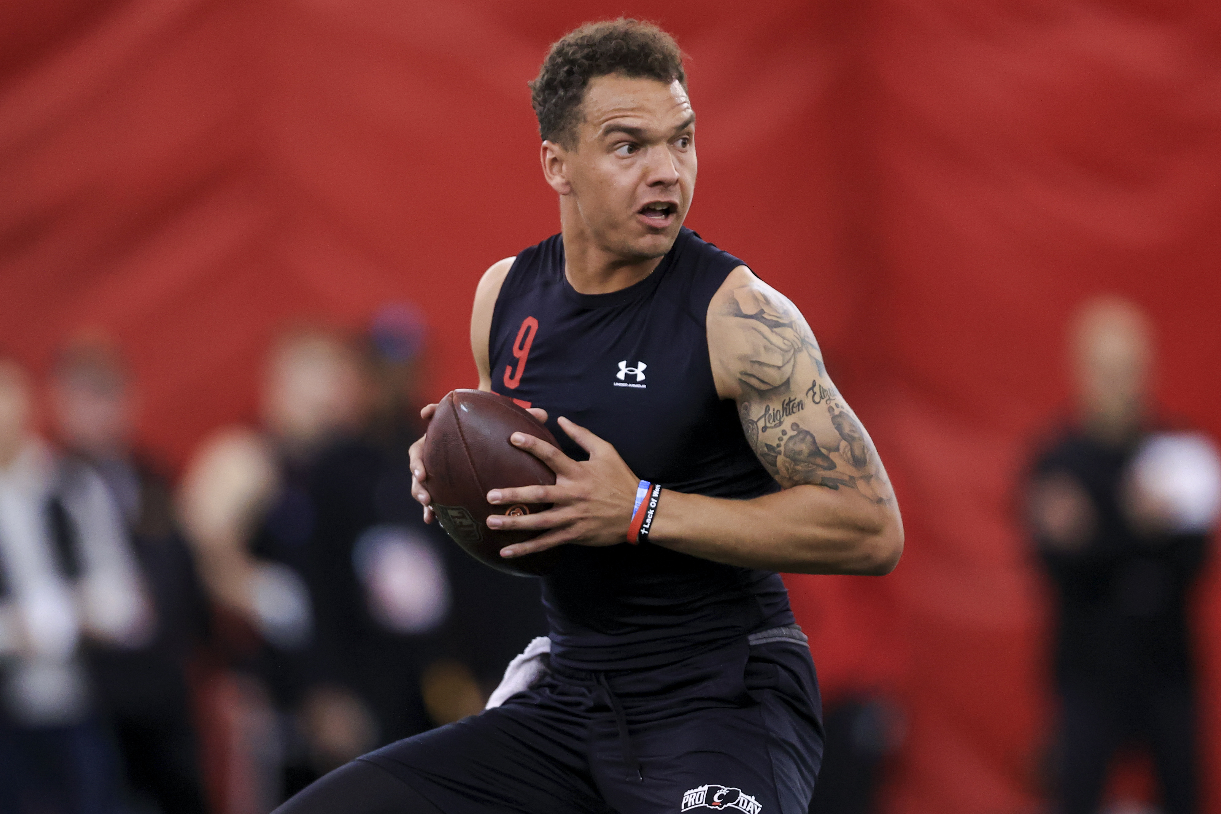 Quarterback Desmond Ridder looks to throw a pass in a football drill during Cincinnati Pro Day in Cincinnati, Thursday, March 24, 2022. (AP Photo/Aaron Doster)