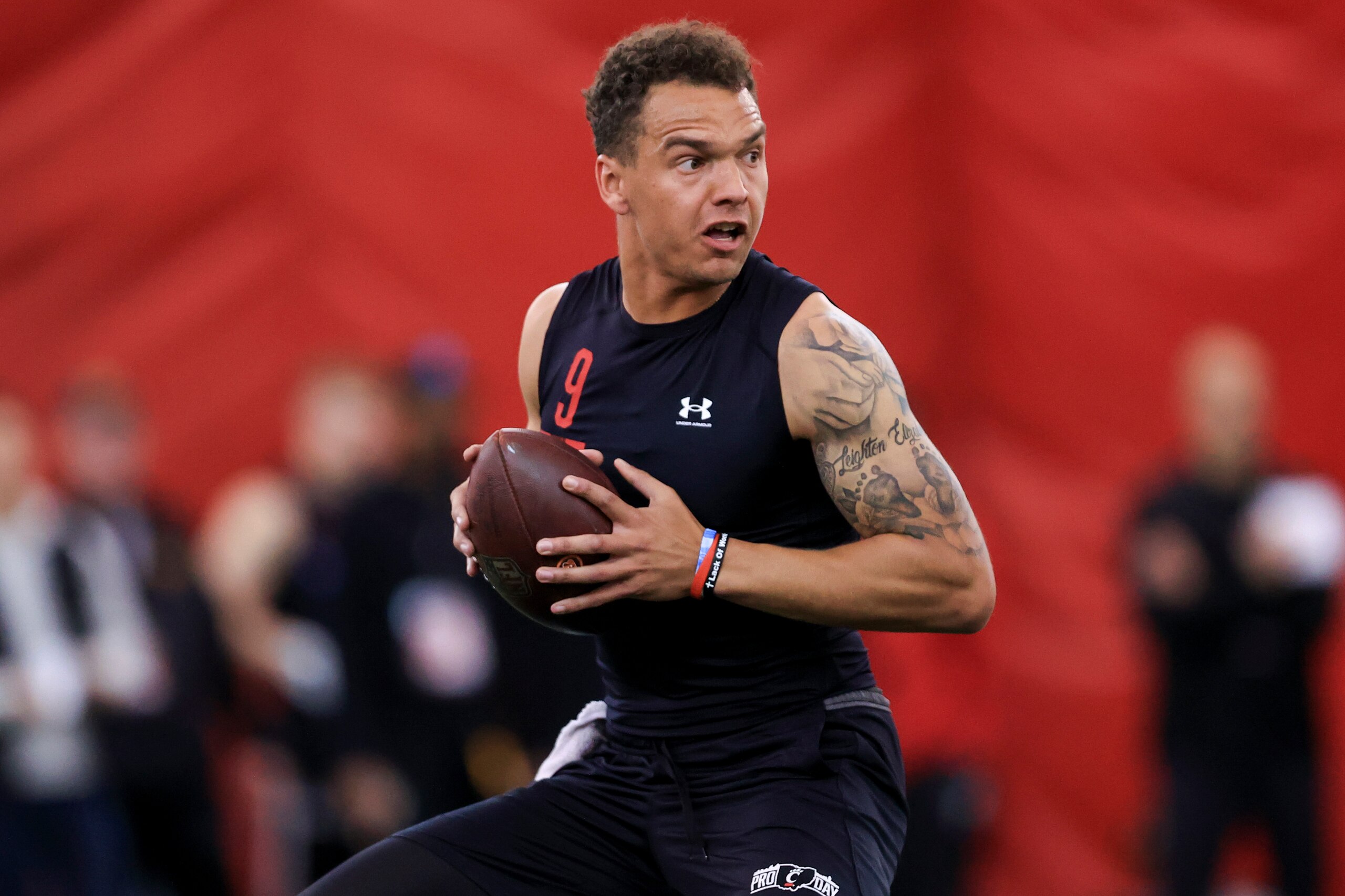 Quarterback Desmond Ridder looks to throw a pass in a football drill during Cincinnati Pro Day in Cincinnati, Thursday, March 24, 2022. (AP Photo/Aaron Doster)