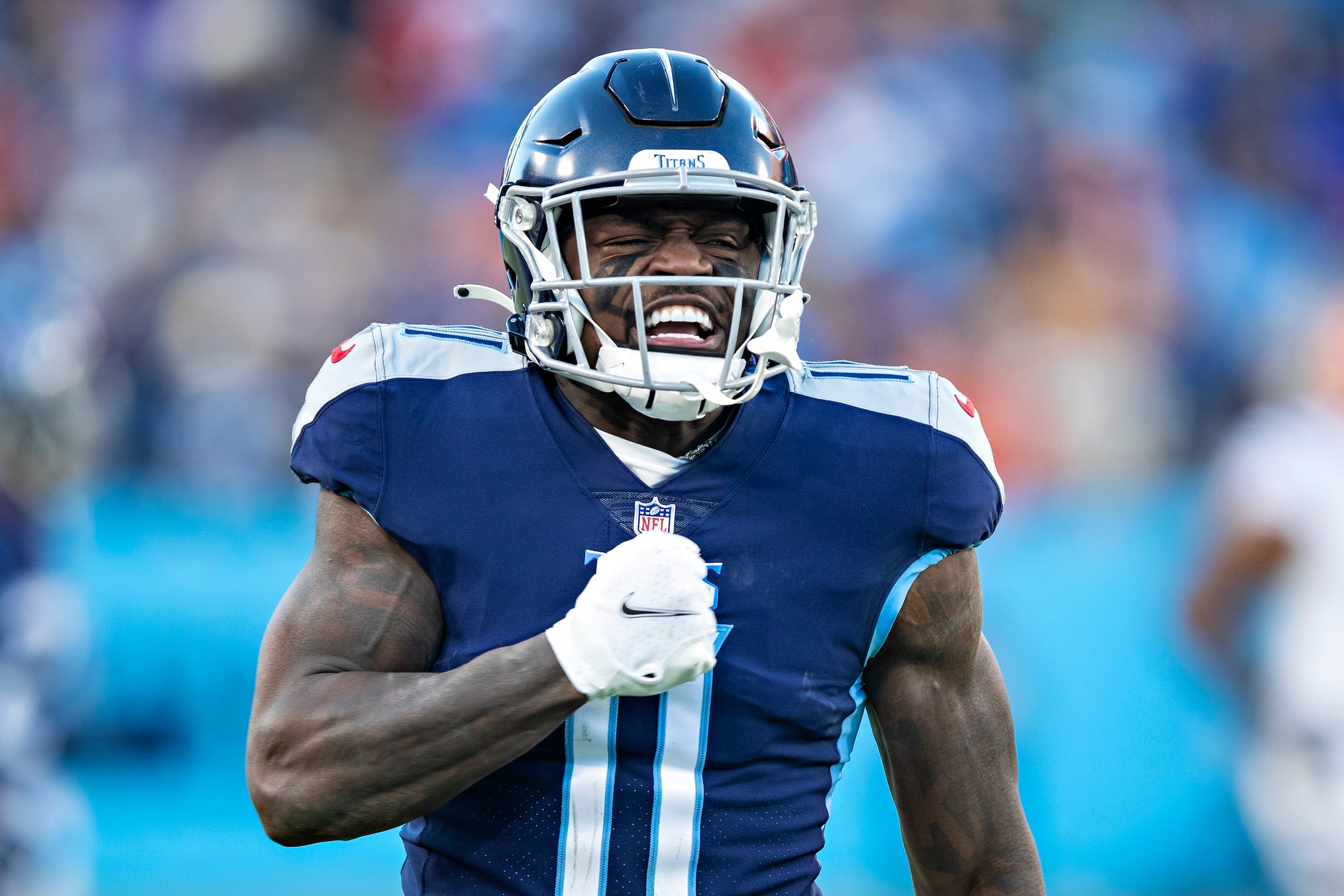 NASHVILLE, TENNESSEE - JANUARY 22: A.J. Brown #11 of the Tennessee Titans celebrates after a big catch during a game against the Cincinnati Bengals in the AFC Divisional Playoff game at Nissan Stadium on January 22, 2022 in Nashville, Tennessee. The Bengals defeated the Titans 19-16.  (Photo by Wesley Hitt/Getty Images)