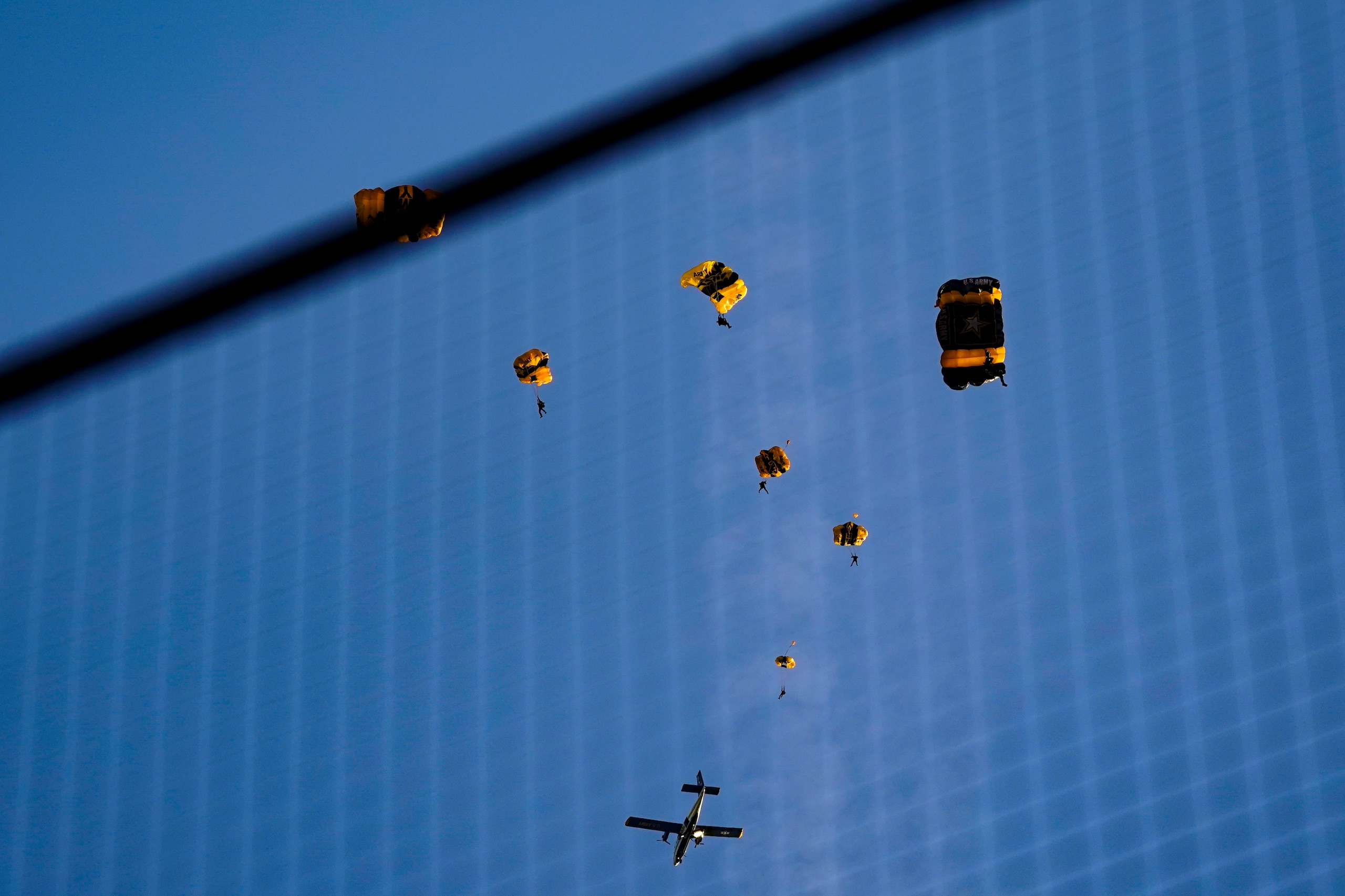 The U.S. Army Parachute Team the Golden Knights jump out of their aircraft before a baseball game between the Washington Nationals and the Arizona Diamondbacks at Nationals Park, Wednesday, April 20, 2022, in Washington. The U.S. Capitol was briefly evacuated after police said they were tracking an aircraft “that poses a probable threat,” but the plane turned out to be the military aircraft with people parachuting out of it for a demonstration at the Nationals game, officials told The Associated Press. (AP Photo/Alex Brandon)