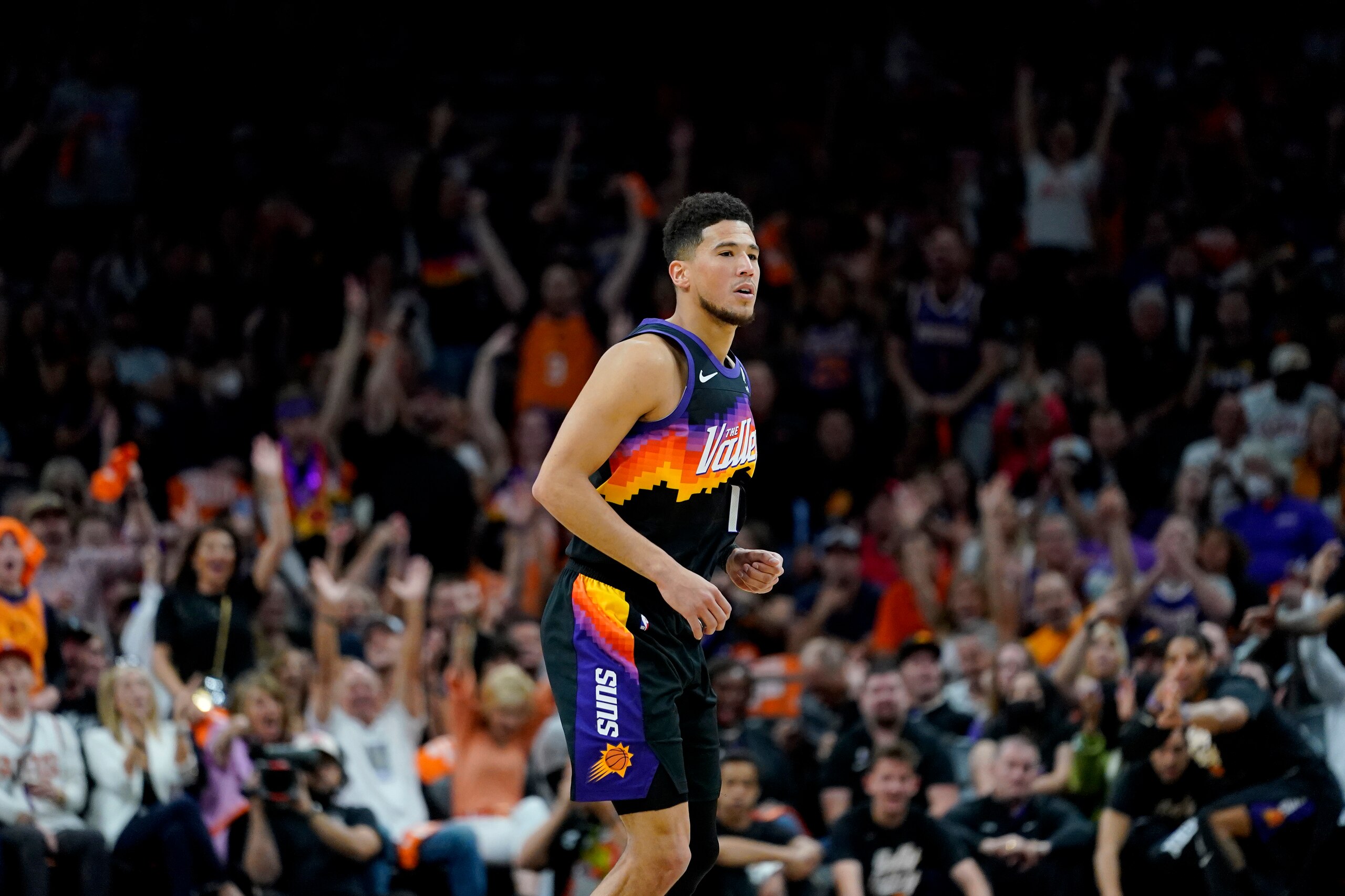 Phoenix Suns guard Devin Booker (1) defends during the first half of Game 2 of an NBA basketball first-round playoff series against the New Orleans Pelicans, Tuesday, April 19, 2022, in Phoenix. (AP Photo/Matt York)