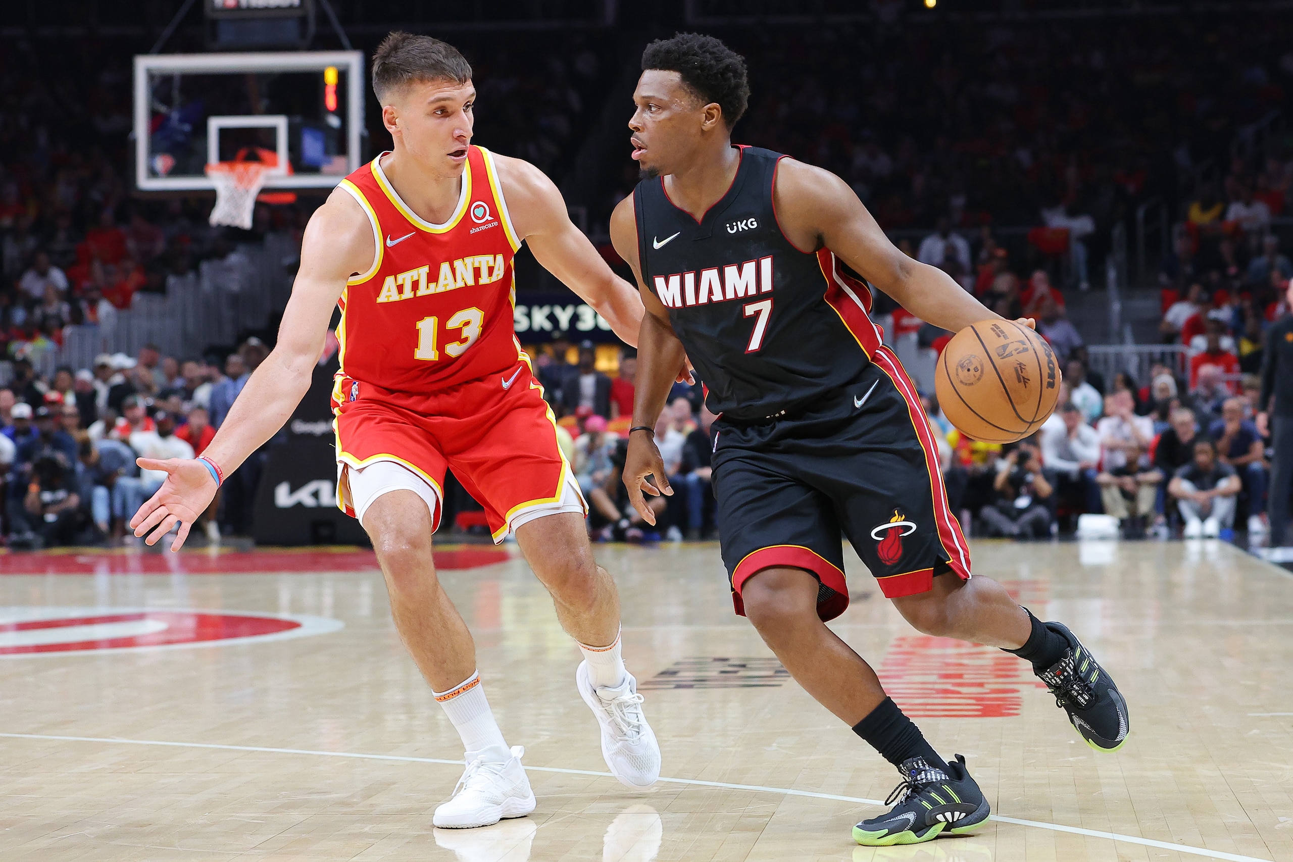 ATLANTA, GEORGIA - APRIL 22: Kyle Lowry #7 of the Miami Heat dribbles against Bogdan Bogdanovic #13 of the Atlanta Hawks during the second quarter in Game Three of the Eastern Conference First Round at State Farm Arena on April 22, 2022 in Atlanta, Georgia. NOTE TO USER: User expressly acknowledges and agrees that, by downloading and or using this photograph, User is consenting to the terms and conditions of the Getty Images License Agreement.  (Photo by Kevin C. Cox/Getty Images)
