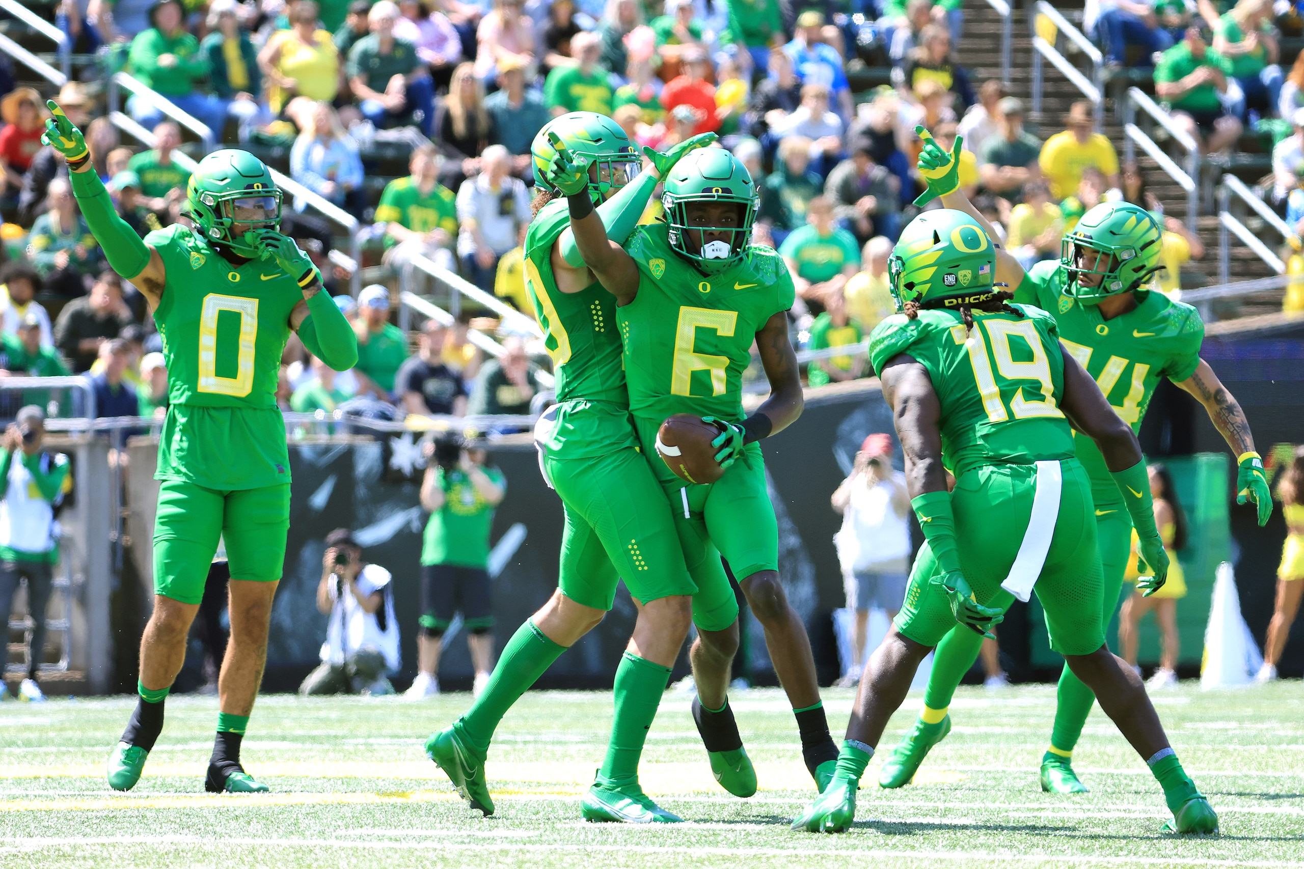 EUGENE, OREGON - APRIL 23: Jahlil Florence #6 of Team Green celebrates with teammates after intercepting a pass during the first quarter against Team Yellow during the Oregon Spring Game at Autzen Stadium on April 23, 2022 in Eugene, Oregon. (Photo by Abbie Parr/Getty Images)