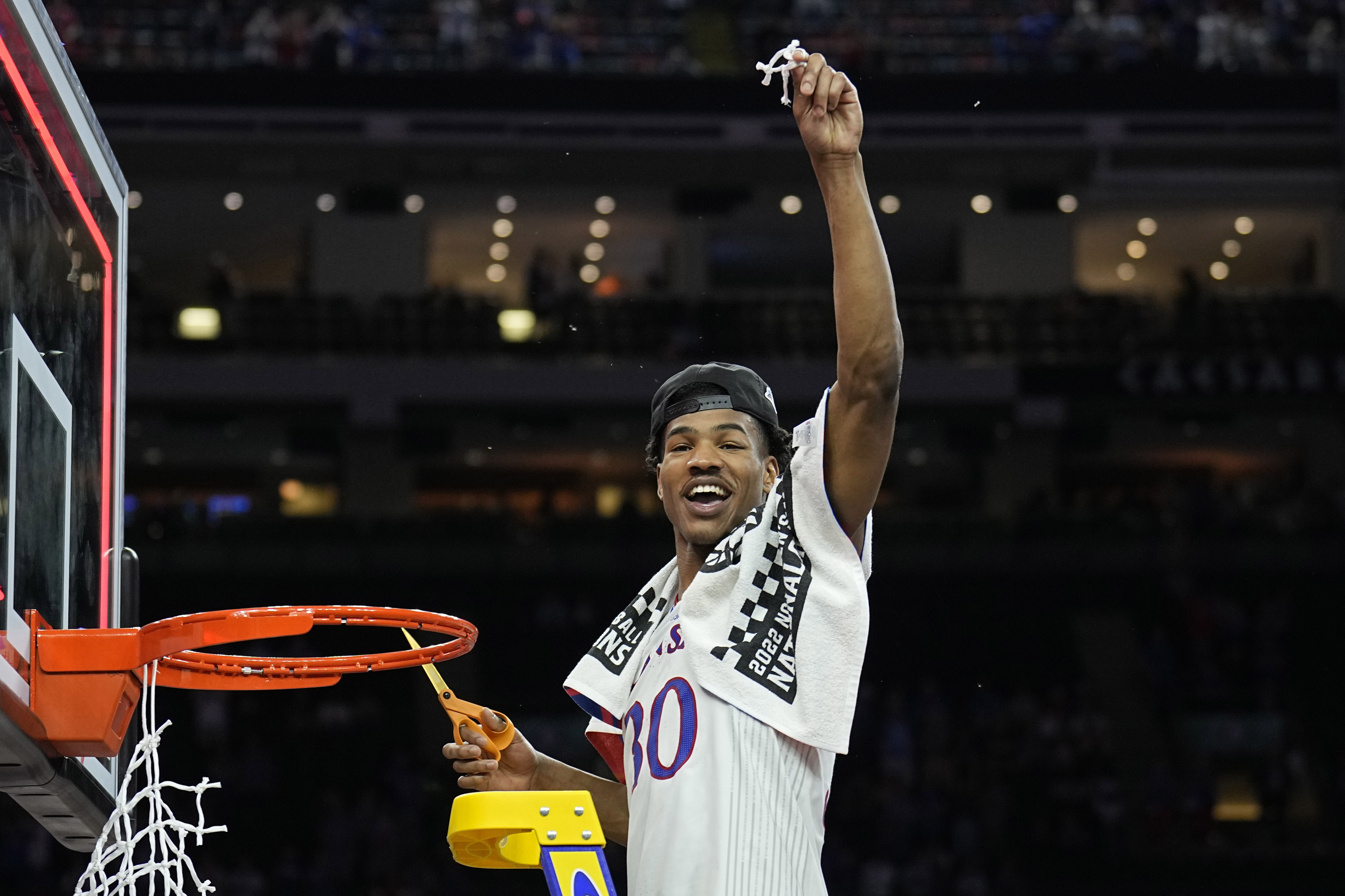 Kansas guard Ochai Agbaji cuts the net after their win against North Carolina in a college basketball game at the finals of the Men's Final Four NCAA tournament, Monday, April 4, 2022, in New Orleans. (AP Photo/Brynn Anderson)