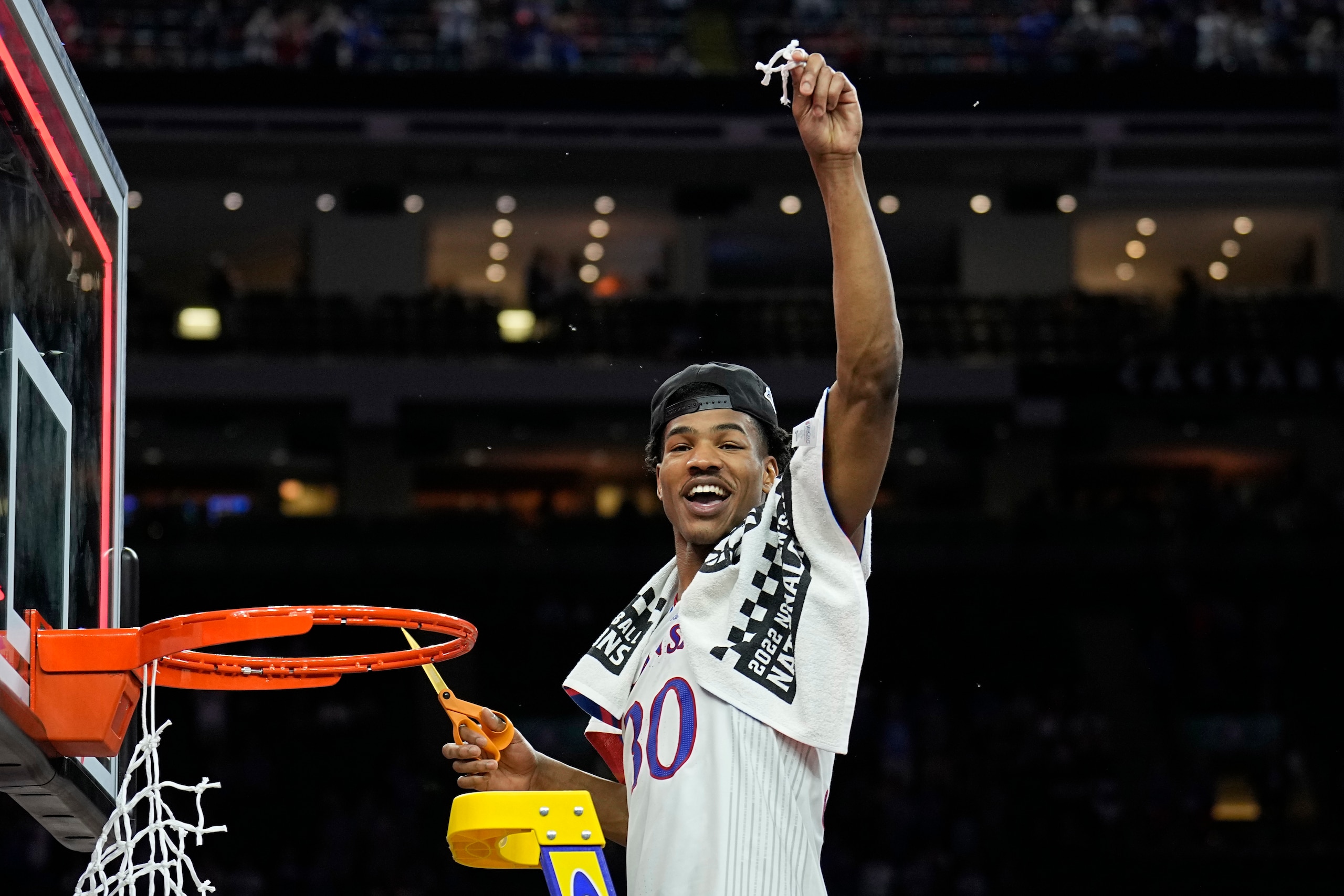 Kansas guard Ochai Agbaji cuts the net after their win against North Carolina in a college basketball game at the finals of the Men's Final Four NCAA tournament, Monday, April 4, 2022, in New Orleans. (AP Photo/Brynn Anderson)