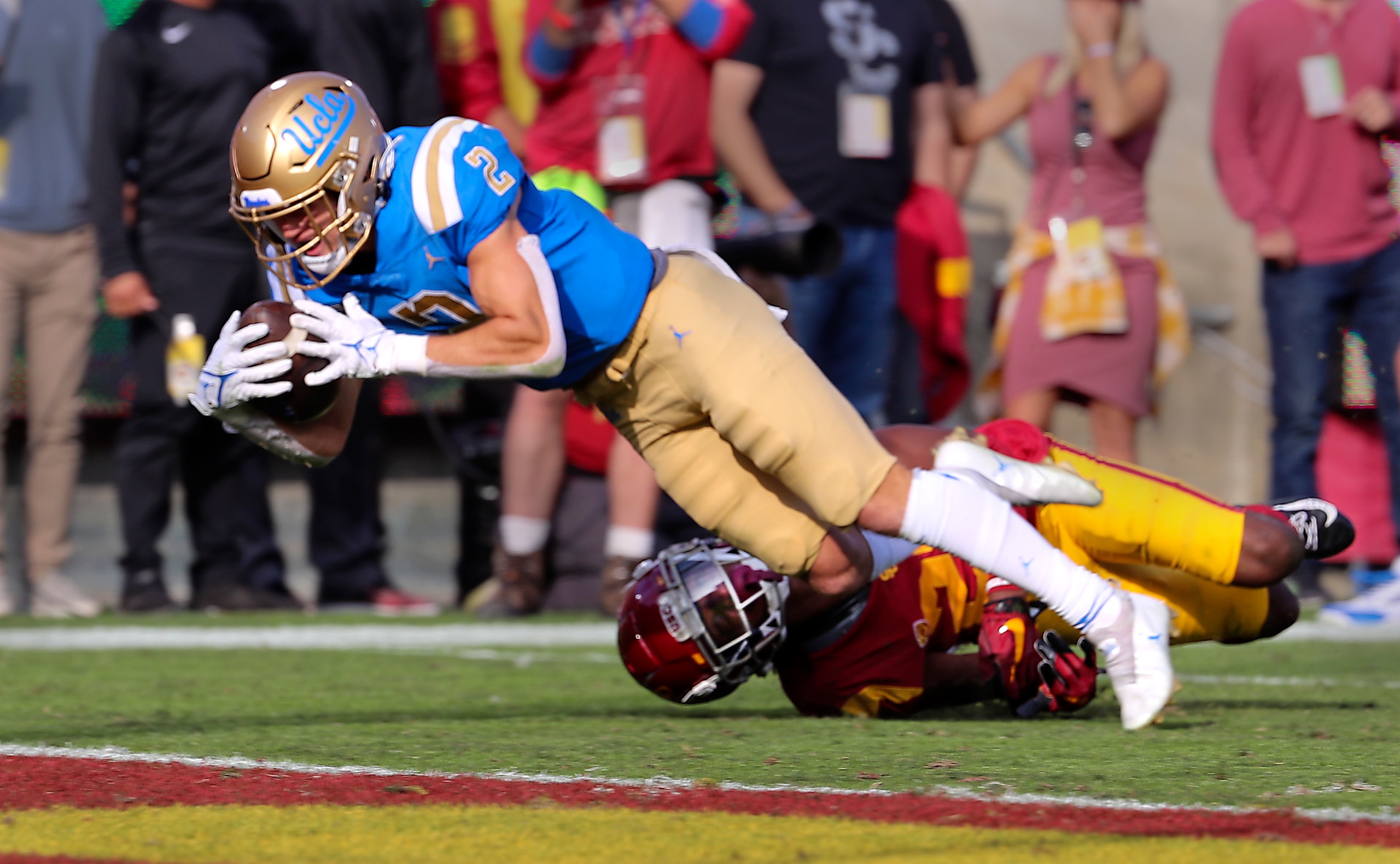 Los Angeles, CA - November 20: UCLA wide receiver Kyle Philips dives into the end zone for a touchdown as USC safety Calen Bullock tries to stop him in the first quarter at Los Angeles Memorial Coliseum in Los Angeles on Saturday, Nov. 20, 2021. (Allen J. Schaben / Los Angeles Times via Getty Images) Los Angeles, CA - November 20: UCLA wide receiver Kyle Philips dives into the end zone for a touchdown as USC safety Calen Bullock tries to stop him in the first quarter at Los Angeles Memorial Coliseum in Los Angeles on Saturday, Nov. 20, 2021. (Allen J. Schaben / Los Angeles Times via Getty Images)