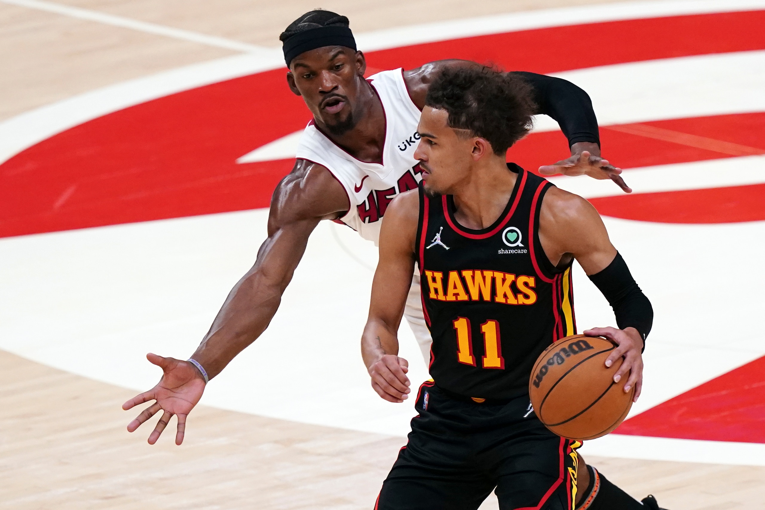 Atlanta Hawks guard Trae Young (11) tries to get past Miami Heat forward Jimmy Butler in the first half of an NBA playoff basketball game Sunday, April 24, 2022, in Atlanta. (AP Photo/John Bazemore) Atlanta Hawks guard Trae Young (11) tries to get past Miami Heat forward Jimmy Butler in the first half of an NBA playoff basketball game Sunday, April 24, 2022, in Atlanta. (AP Photo/John Bazemore)