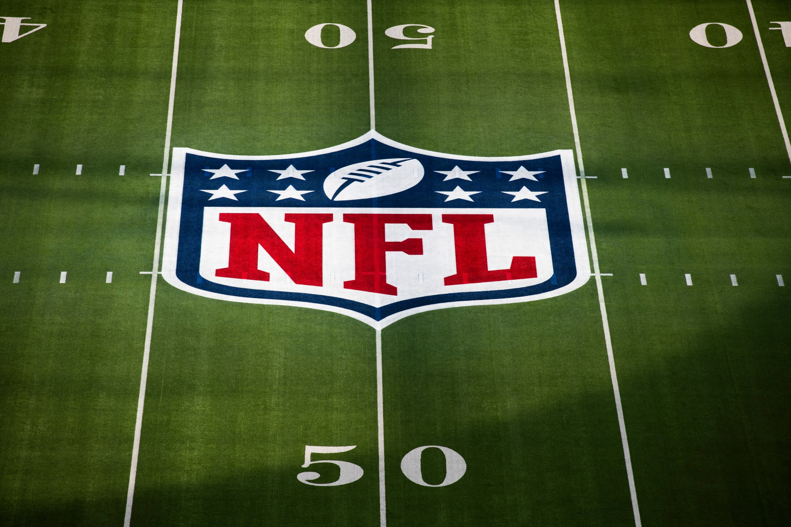 FILE - The National Football League logo appears on the 50 yard line for NFL Super Bowl 56 in Inglewood, Calif., Sunday, Feb. 13, 2022. The NFL is telling a judge there are multiple reasons why a lawsuit brought against it by three Black coaches who allege racist hiring practices should fail. (AP Photo/Kyusung Gong, File)