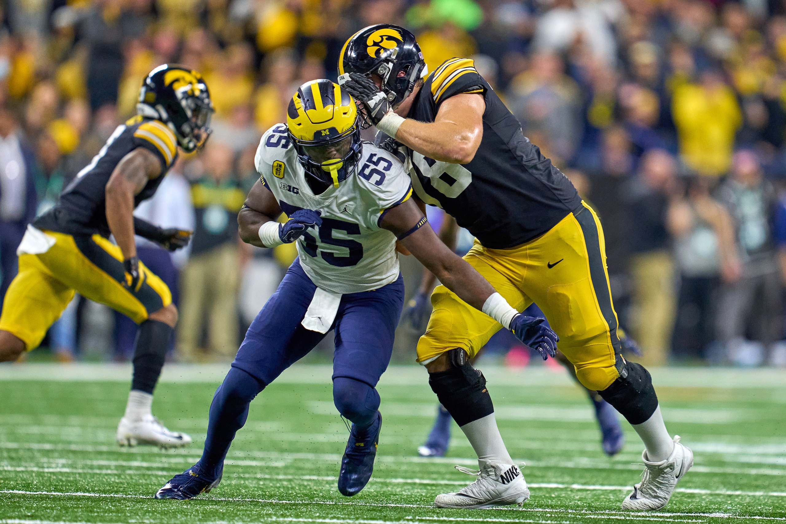 INDIANAPOLIS, IN - DECEMBER 04: Michigan Wolverines linebacker David Ojabo (55) battles with Iowa Hawkeyes offensive lineman Mason Richman (78) during the Big Ten Championship Game between the Iowa Hawkeyes and the Michigan Wolverines on December 04, 2021, at Lucas Oil Stadium, in Indianapolis, IL. (Photo by Robin Alam/Icon Sportswire via Getty Images)