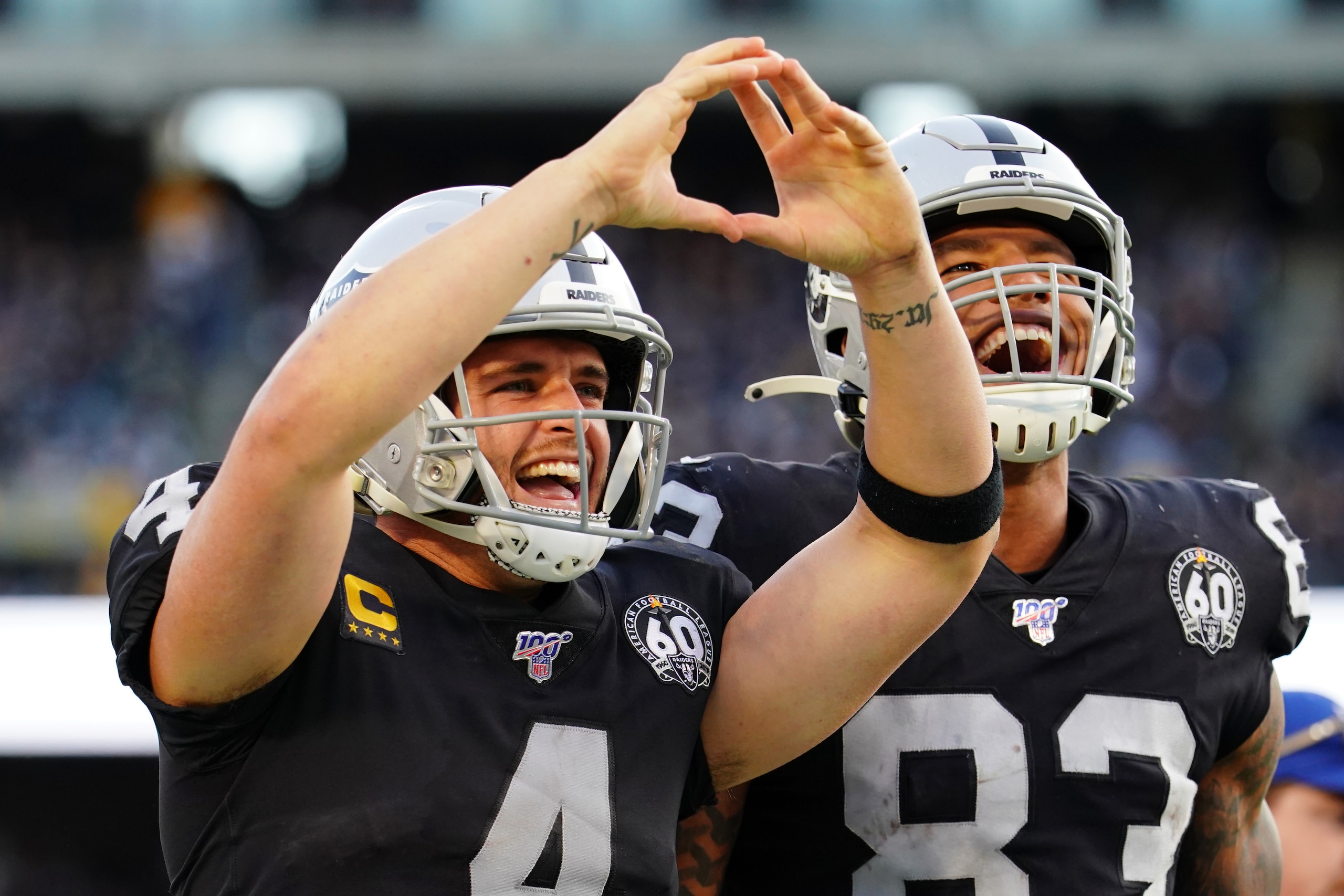 OAKLAND, CALIFORNIA - DECEMBER 15: Derek Carr #4 of the Oakland Raiders celebrates a first down with Darren Waller #83 during the second half against the Jacksonville Jaguars at RingCentral Coliseum on December 15, 2019 in Oakland, California. (Photo by Daniel Shirey/Getty Images)