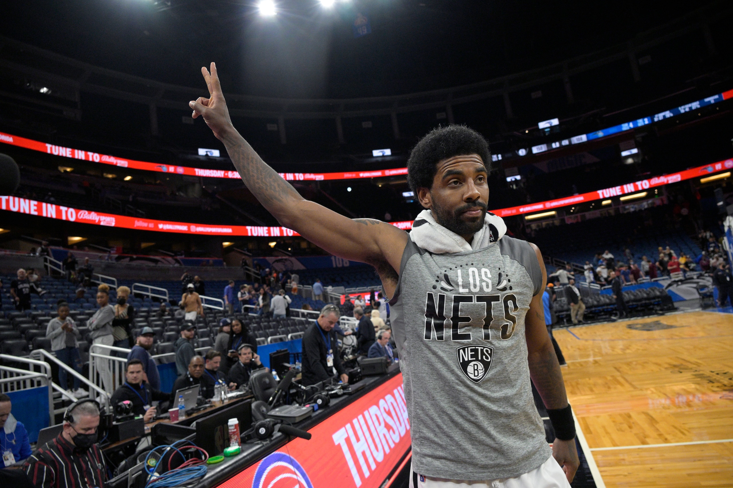 Brooklyn Nets guard Kyrie Irving acknowledges fans in the stands while leaving the court after an NBA basketball game against the Orlando Magic, Tuesday, March 15, 2022, in Orlando, Fla. (AP Photo/Phelan M. Ebenhack)