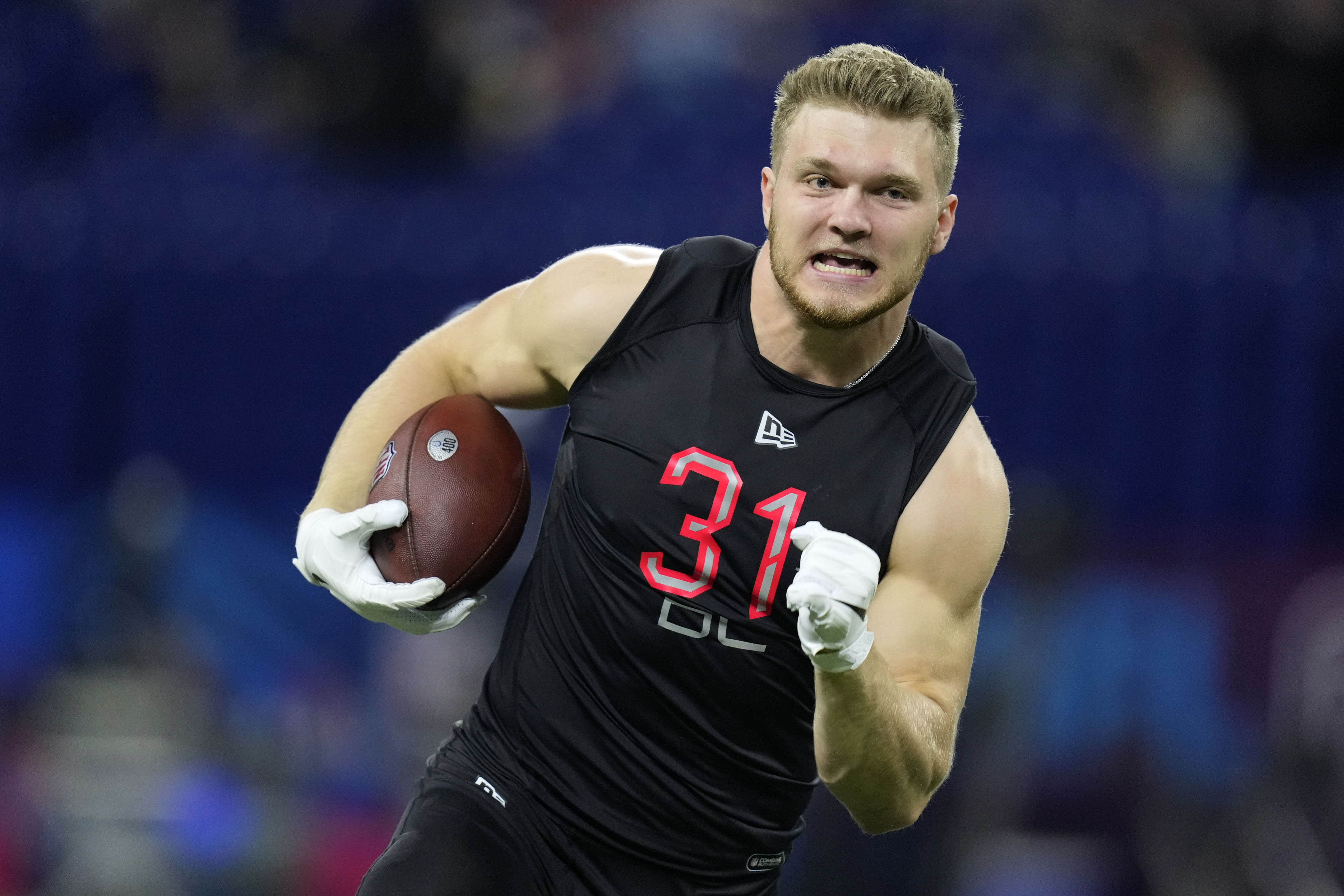 Michigan defensive lineman Aidan Hutchinson runs during a drill at the NFL football scouting combine, Saturday, March 5, 2022, in Indianapolis. (AP Photo/Charlie Neibergall)
