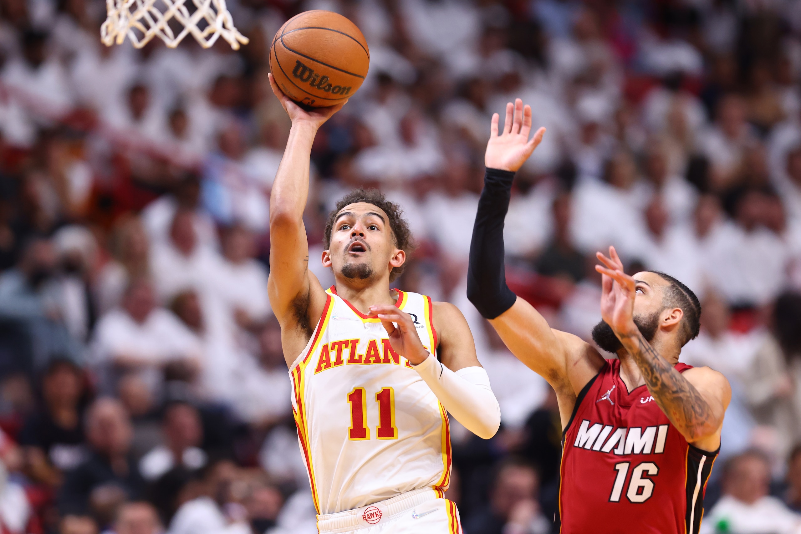 MIAMI, FLORIDA - APRIL 26: Trae Young #11 of the Atlanta Hawks shoots against Caleb Martin #16 of the Miami Heat during the first half in Game Five of the Eastern Conference First Round at FTX Arena on April 26, 2022 in Miami, Florida. NOTE TO USER: User expressly acknowledges and agrees that, by downloading and or using this photograph, User is consenting to the terms and conditions of the Getty Images License Agreement.  (Photo by Michael Reaves/Getty Images)