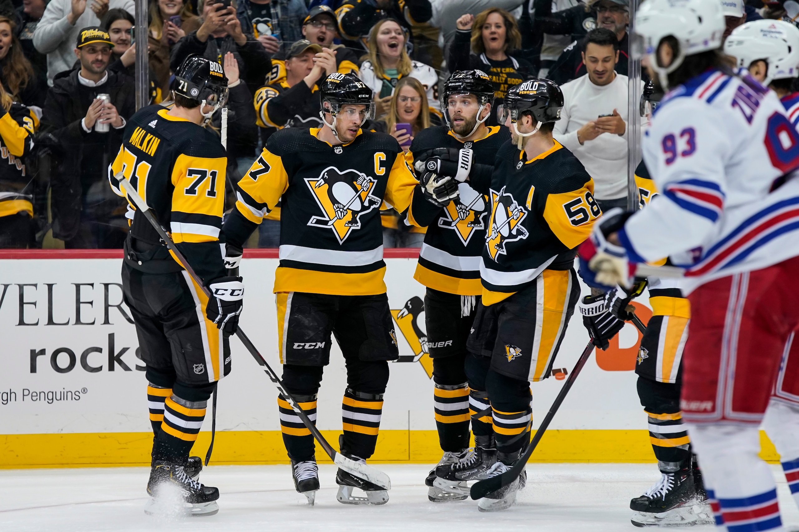 PITTSBURGH, PA - MARCH 29: Pittsburgh Penguins Center Sidney Crosby (87) celebrates his goal with teammates during the third period in the NHL game between the Pittsburgh Penguins and the New York Rangers on March 29, 2022, at PPG Paints Arena in Pittsburgh, PA. (Photo by Jeanine Leech/Icon Sportswire via Getty Images)