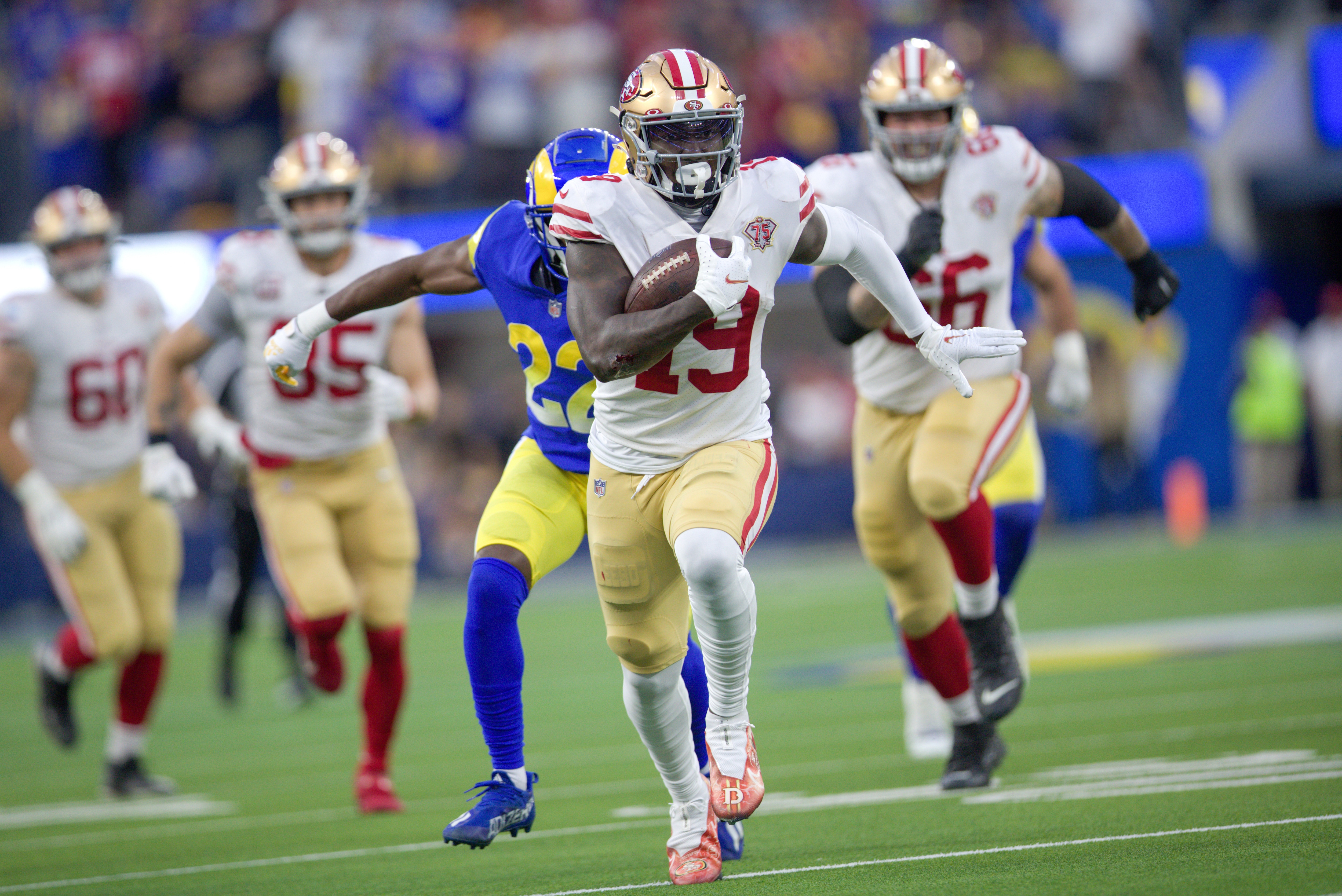INGLEWOOD, CA - JANUARY 30: Deebo Samuel #19 of the San Francisco 49ers heads to the end zone on a 44-yard touchdown catch during the game against the Los Angeles Rams at SoFi Stadium on January 30, 2022 in Inglewood, California. The Rams defeated the 49ers 20-17. (Photo by Michael Zagaris/San Francisco 49ers/Getty Images)