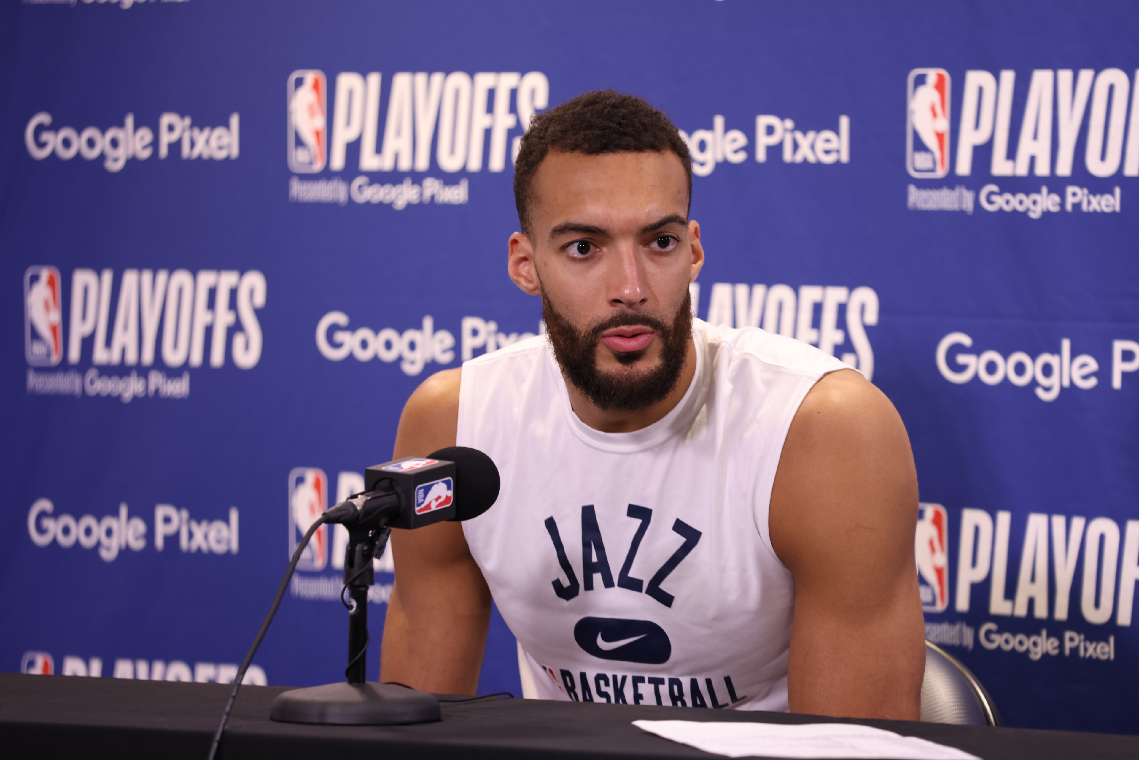 SALT LAKE CITY, UT - APRIL 23: Rudy Gobert #27 of the Utah Jazz talks to the media after Round 1 Game 4 of the 2022 NBA Playoffs against the Dallas Mavericks on April 23, 2022 at vivint.SmartHome Arena in Salt Lake City, Utah. NOTE TO USER: User expressly acknowledges and agrees that, by downloading and or using this Photograph, User is consenting to the terms and conditions of the Getty Images License Agreement. Mandatory Copyright Notice: Copyright 2022 NBAE (Photo by Melissa Majchrzak/NBAE via Getty Images) SALT LAKE CITY, UT - APRIL 23: Rudy Gobert #27 of the Utah Jazz talks to the media after Round 1 Game 4 of the 2022 NBA Playoffs against the Dallas Mavericks on April 23, 2022 at vivint.SmartHome Arena in Salt Lake City, Utah. NOTE TO USER: User expressly acknowledges and agrees that, by downloading and or using this Photograph, User is consenting to the terms and conditions of the Getty Images License Agreement. Mandatory Copyright Notice: Copyright 2022 NBAE (Photo by Melissa Majchrzak/NBAE via Getty Images)